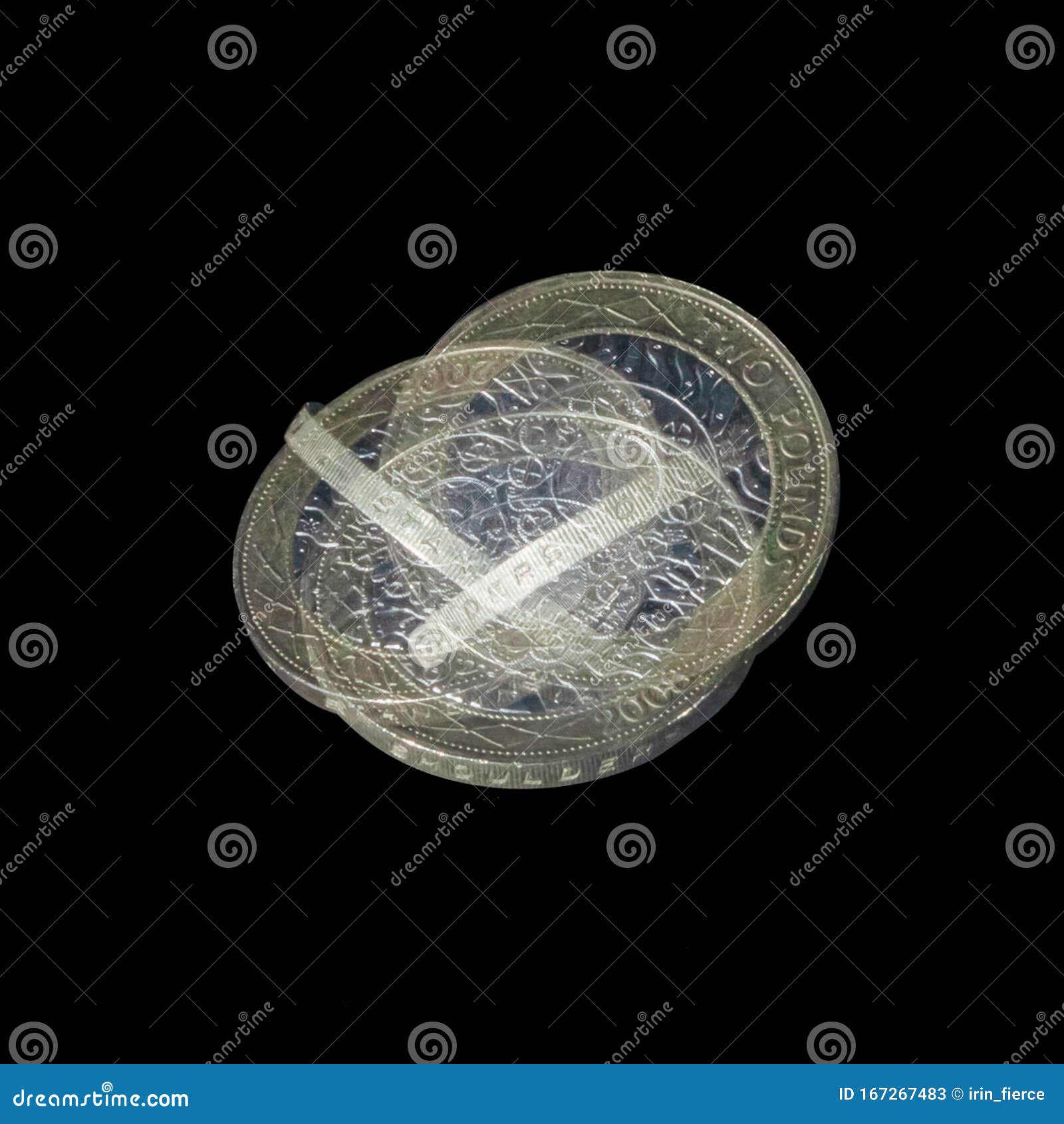 spinning coin in stroboscopic light  on black background. two pounds coin