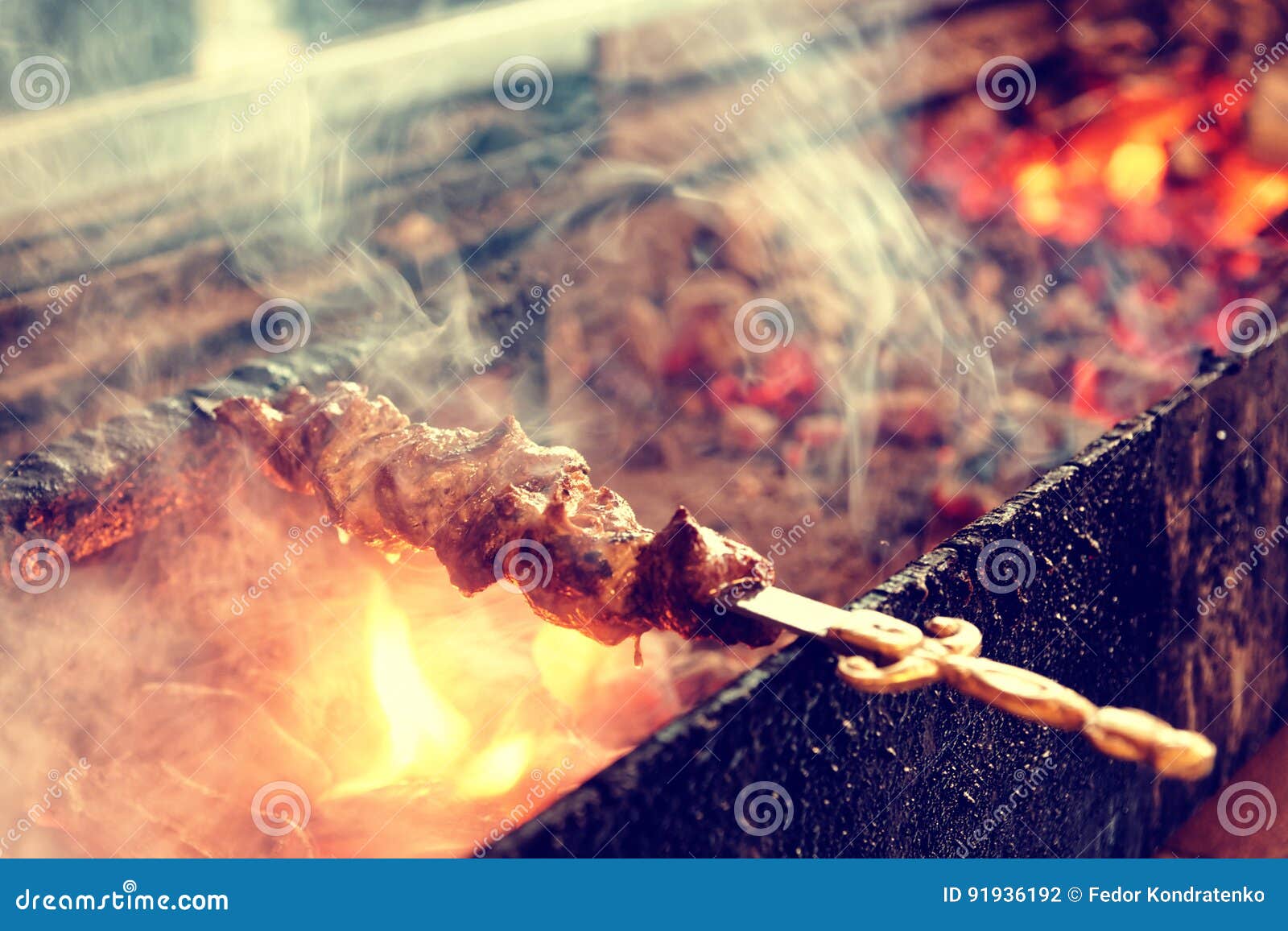 Spit Roasted Meat on a Charcoal Grill, Toned Stock Photo Image of