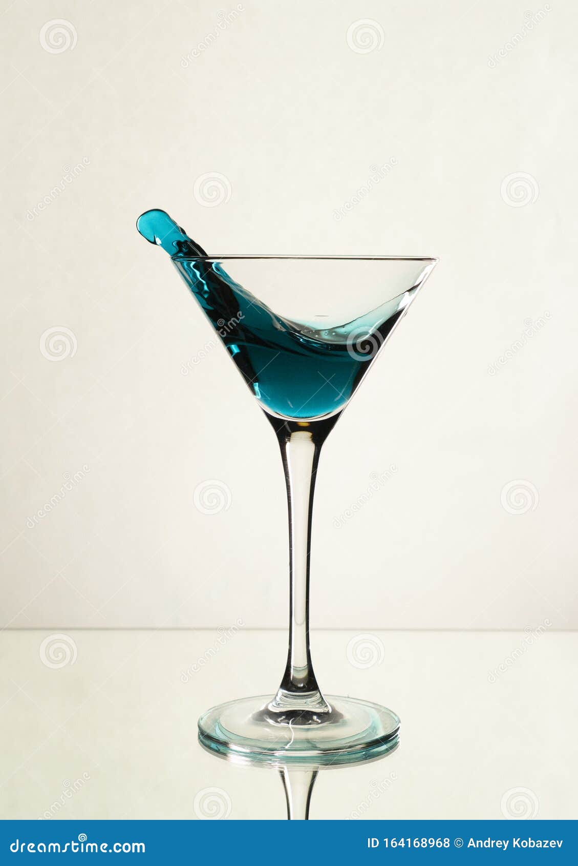 A Splash of Blue Alcohol in a Martini Glass Stock Photo Image of