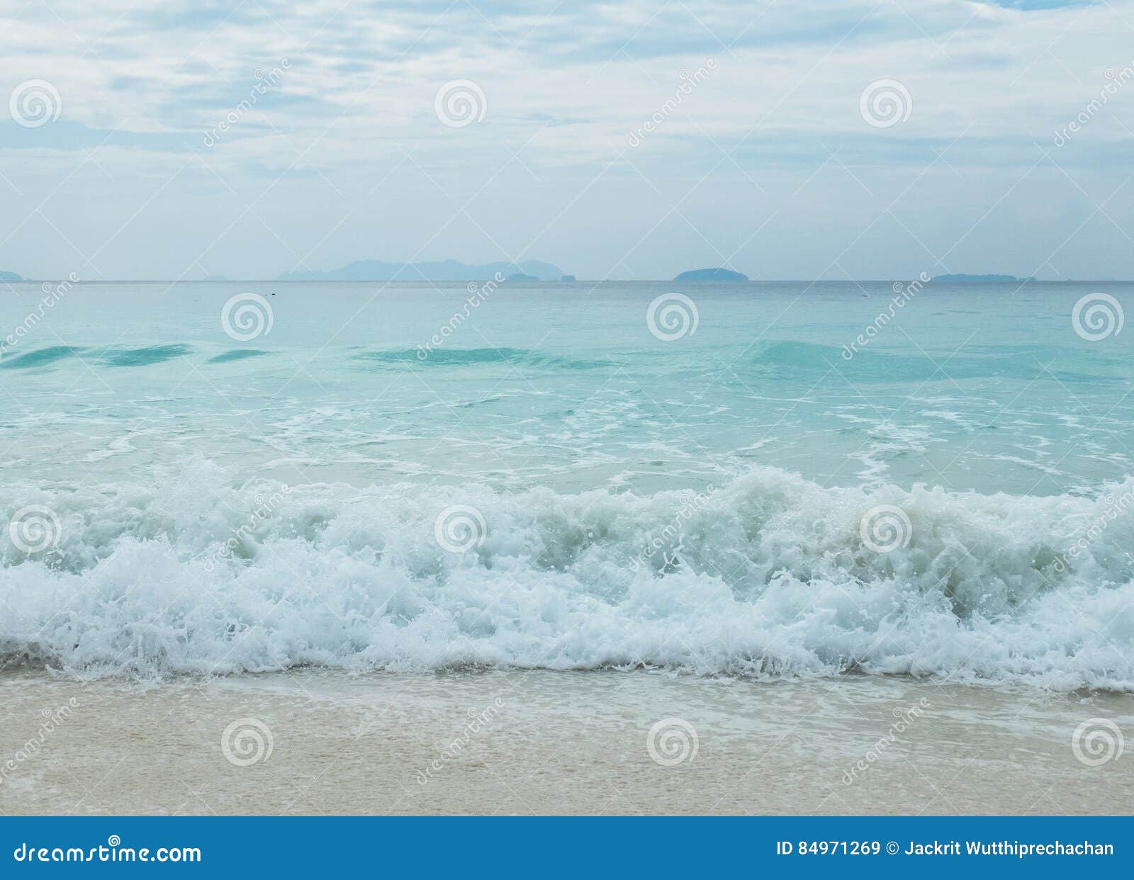 splashing waves from the blue sea to the clear white sand beach in myanmar with copyspace to input text