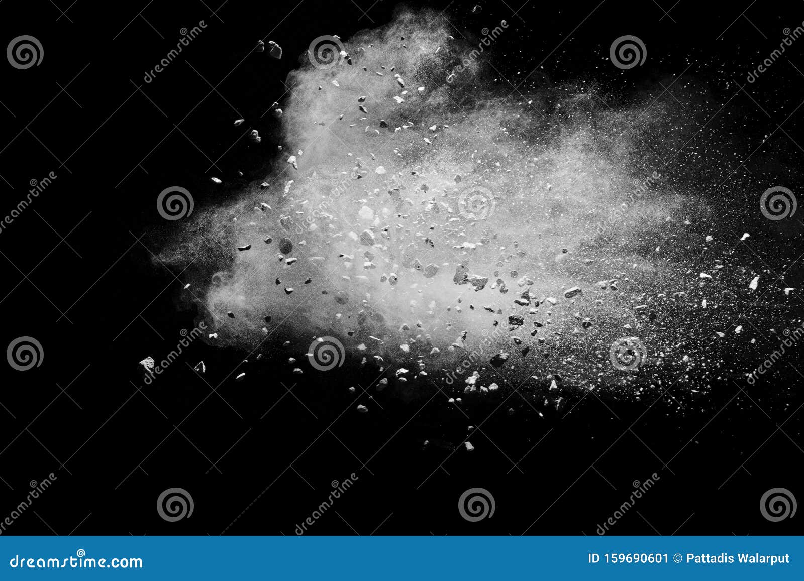 split debris of stone exploding with white powder against black background
