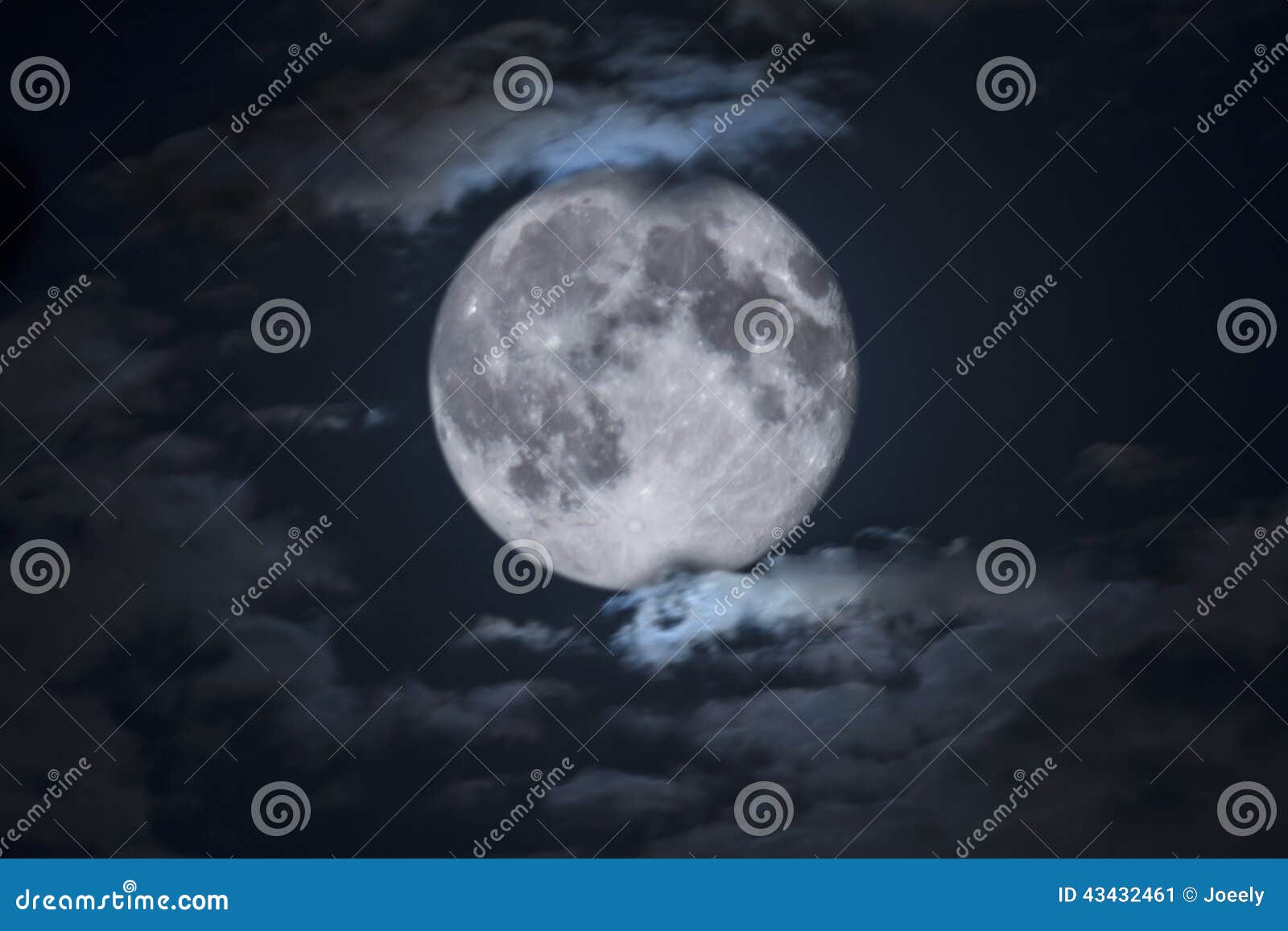 spooky full halloween moon framed by clouds