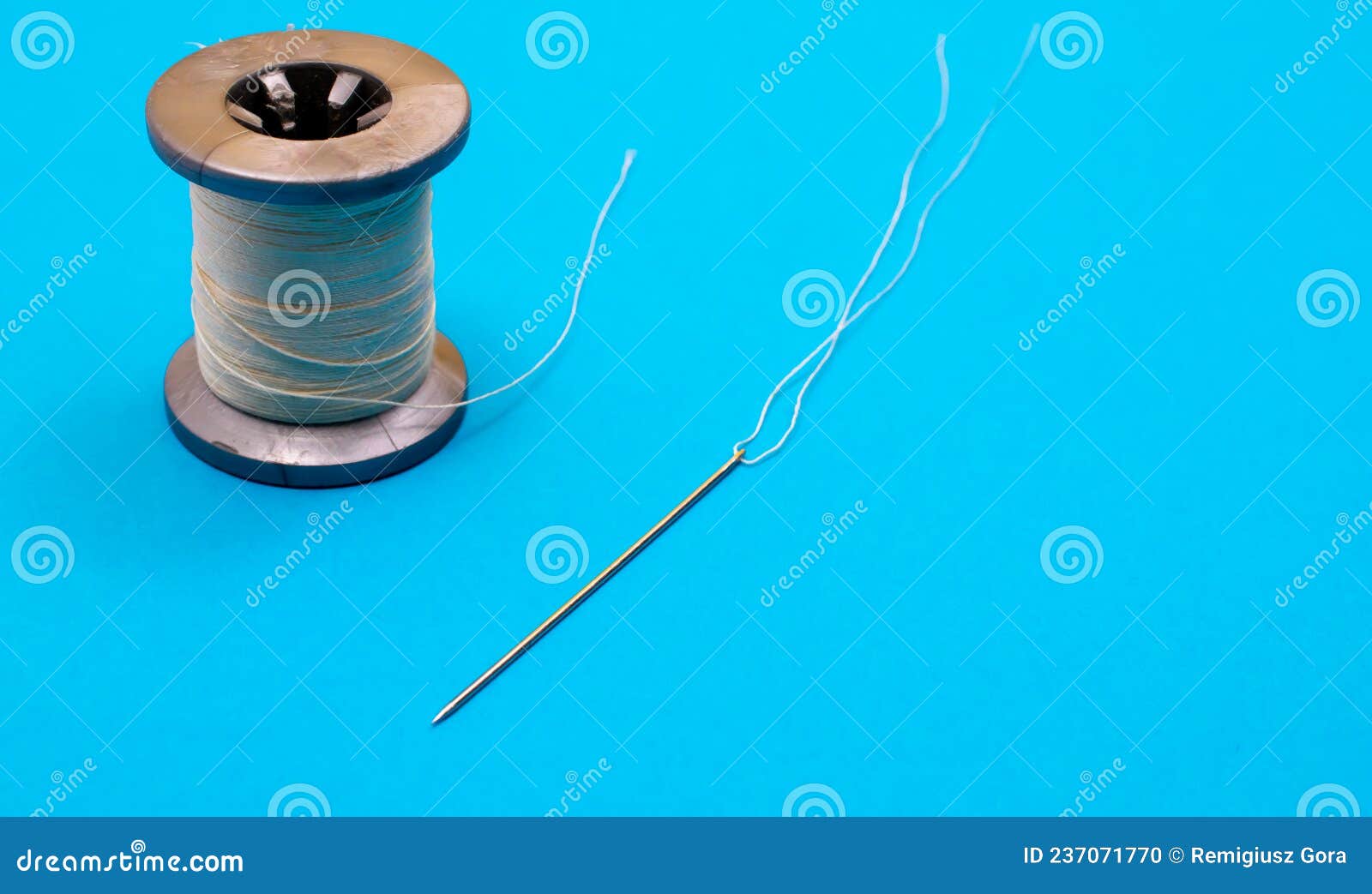 A Spool of Thread and a Needle with a Thread Stock Photo - Image of ...
