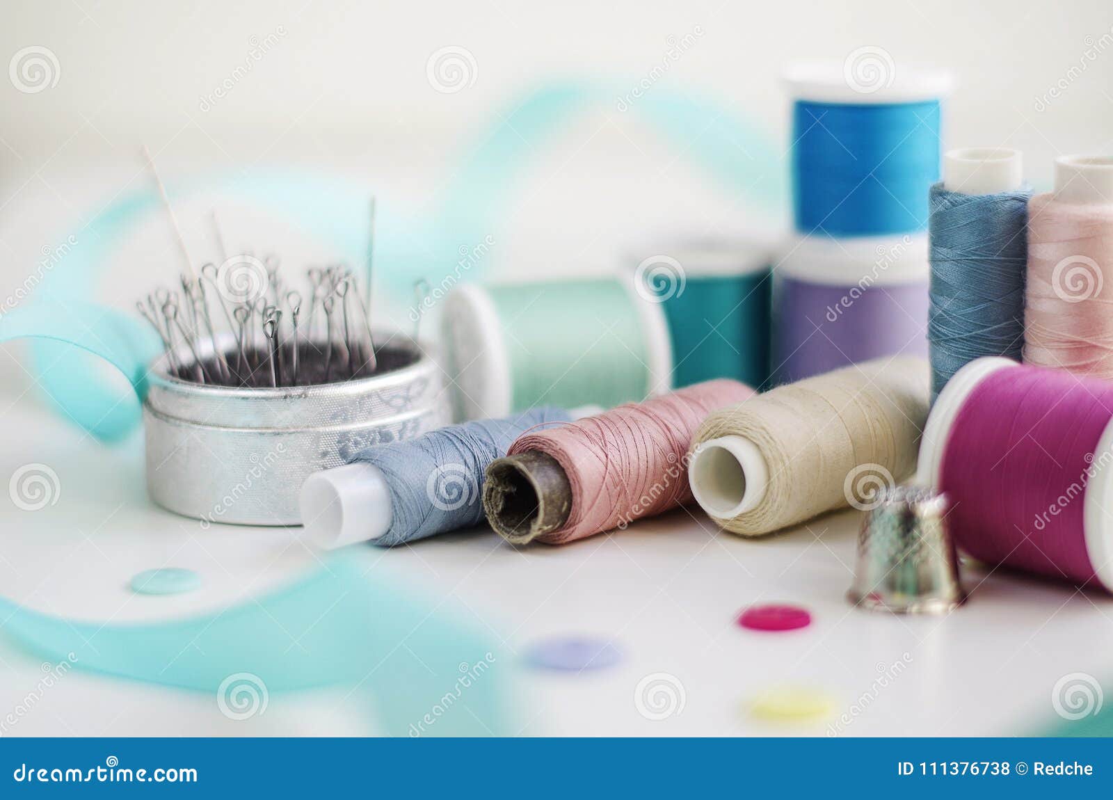 Spools of Thread and Basic Sewing Tools Including Pins, Needle, a