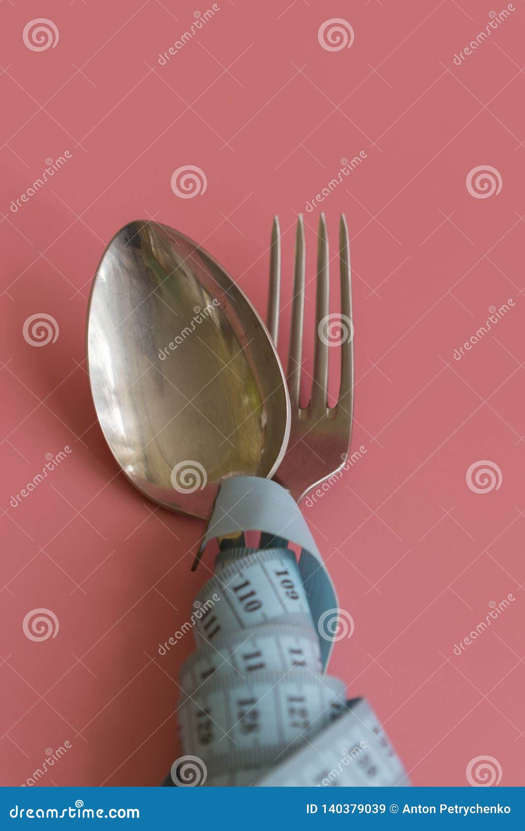 Closeup shot of a pink measuring tape and silverware- diet, weight loss  concept Stock Photo by wirestock