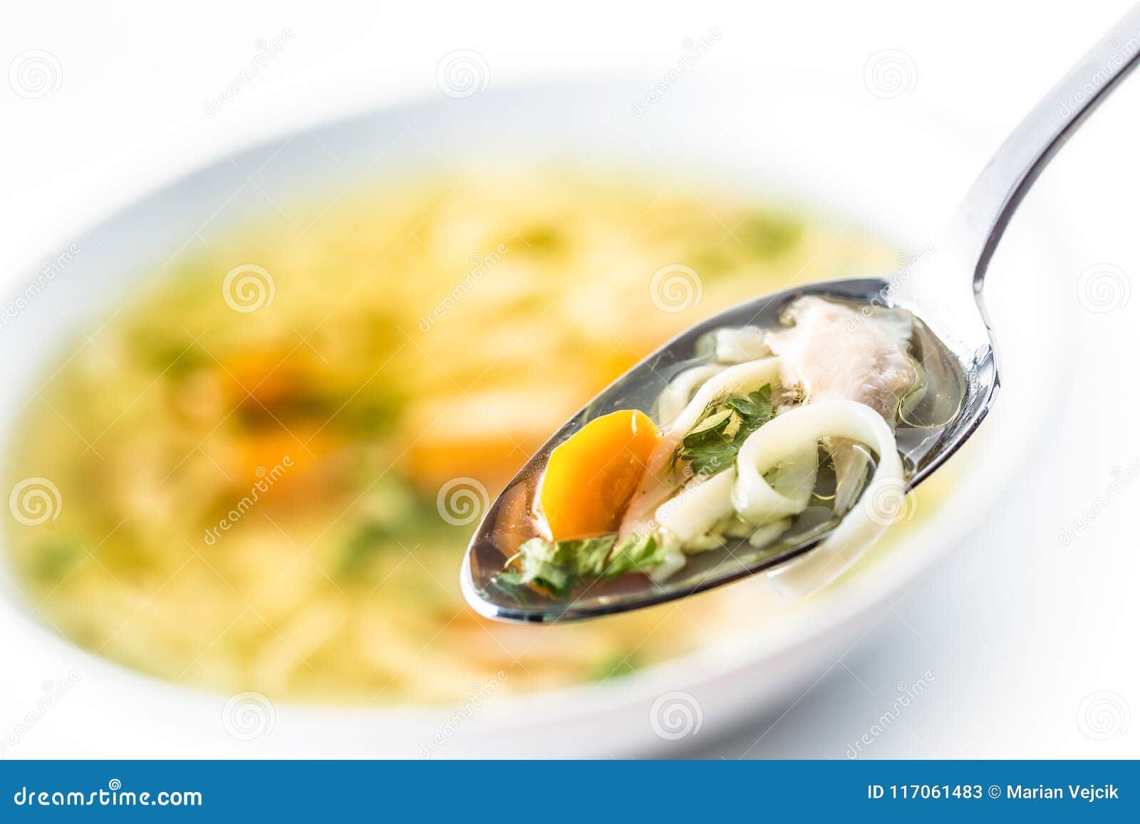 Spoon Full of Chicken or Beef Soup with Noodles Carrot and Herbs Stock