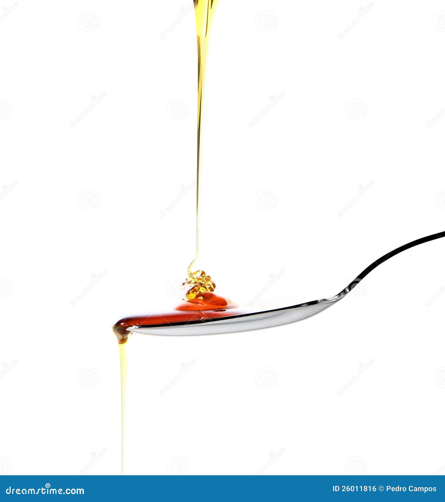 Spoon of honey. Dropping honey on a spoon isolated