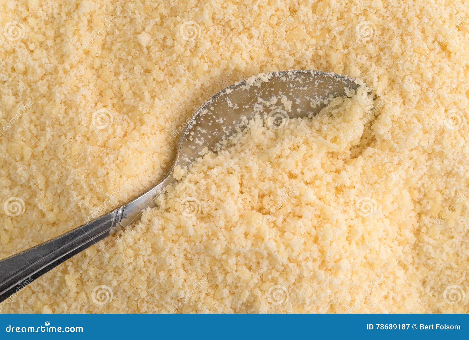 Spoon in parmesan cheese stock image. Image of yellow 78689187