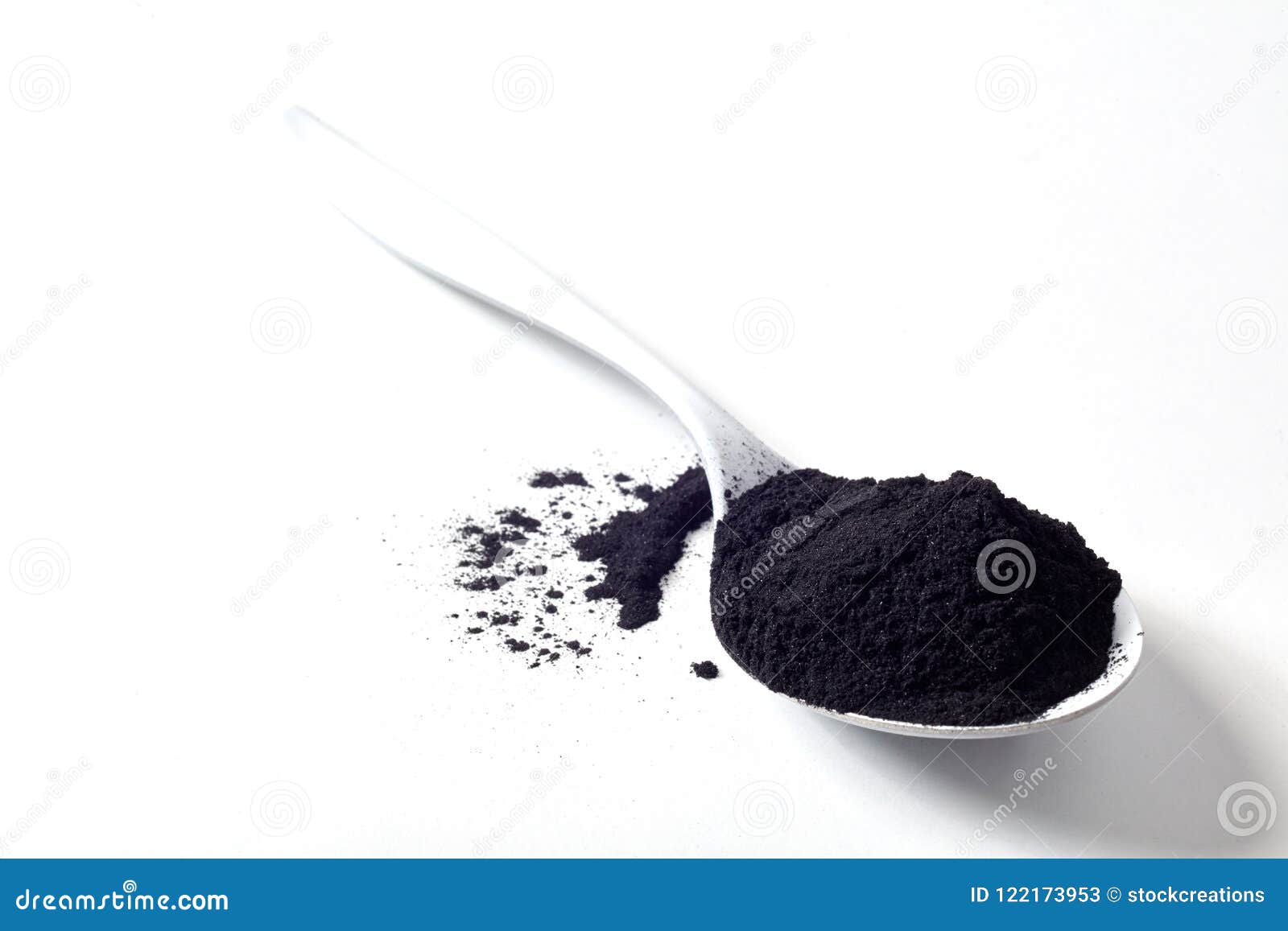 spoon of round activated black plant charcoal
