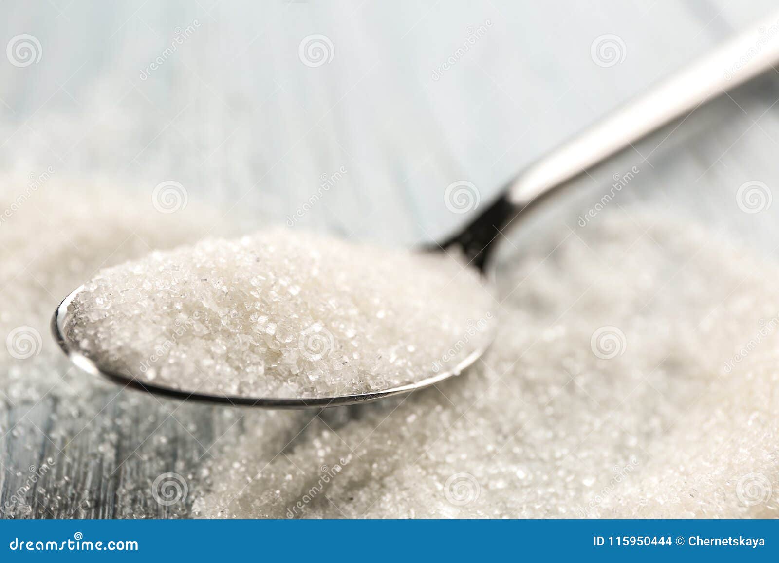Spoon with sugar on table stock photo. Image of full 115950444