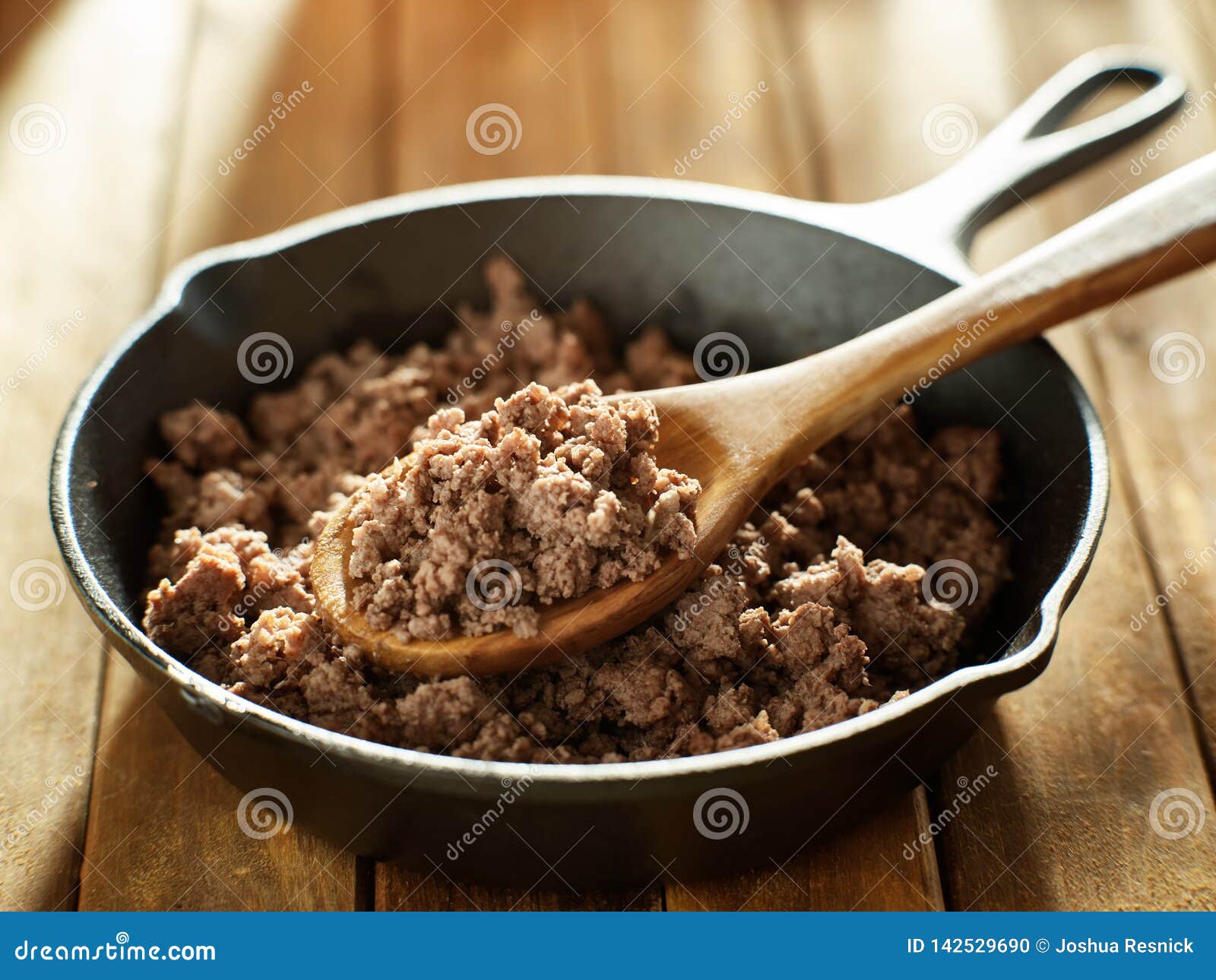 spoonful of freshly cooked ground beef from iron skillet