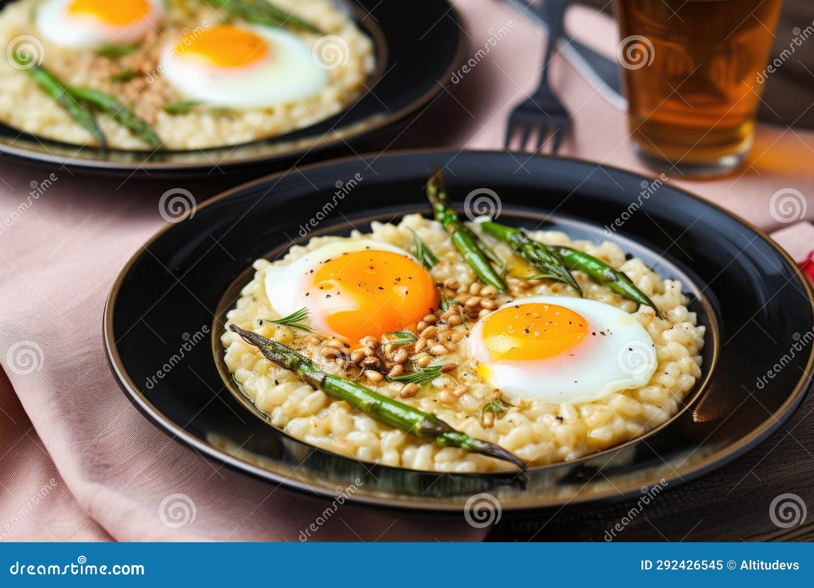 Spooning Risotto with Cut Asparagus and Cooked Quail Eggs Onto a Plate