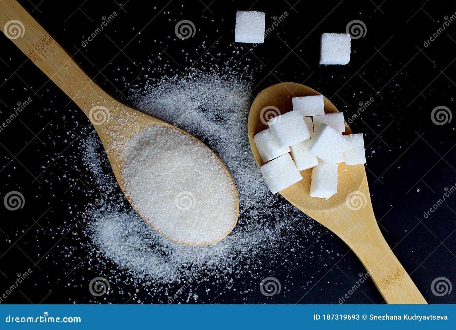 spoons with crumbly sugar and raffinate on a black background