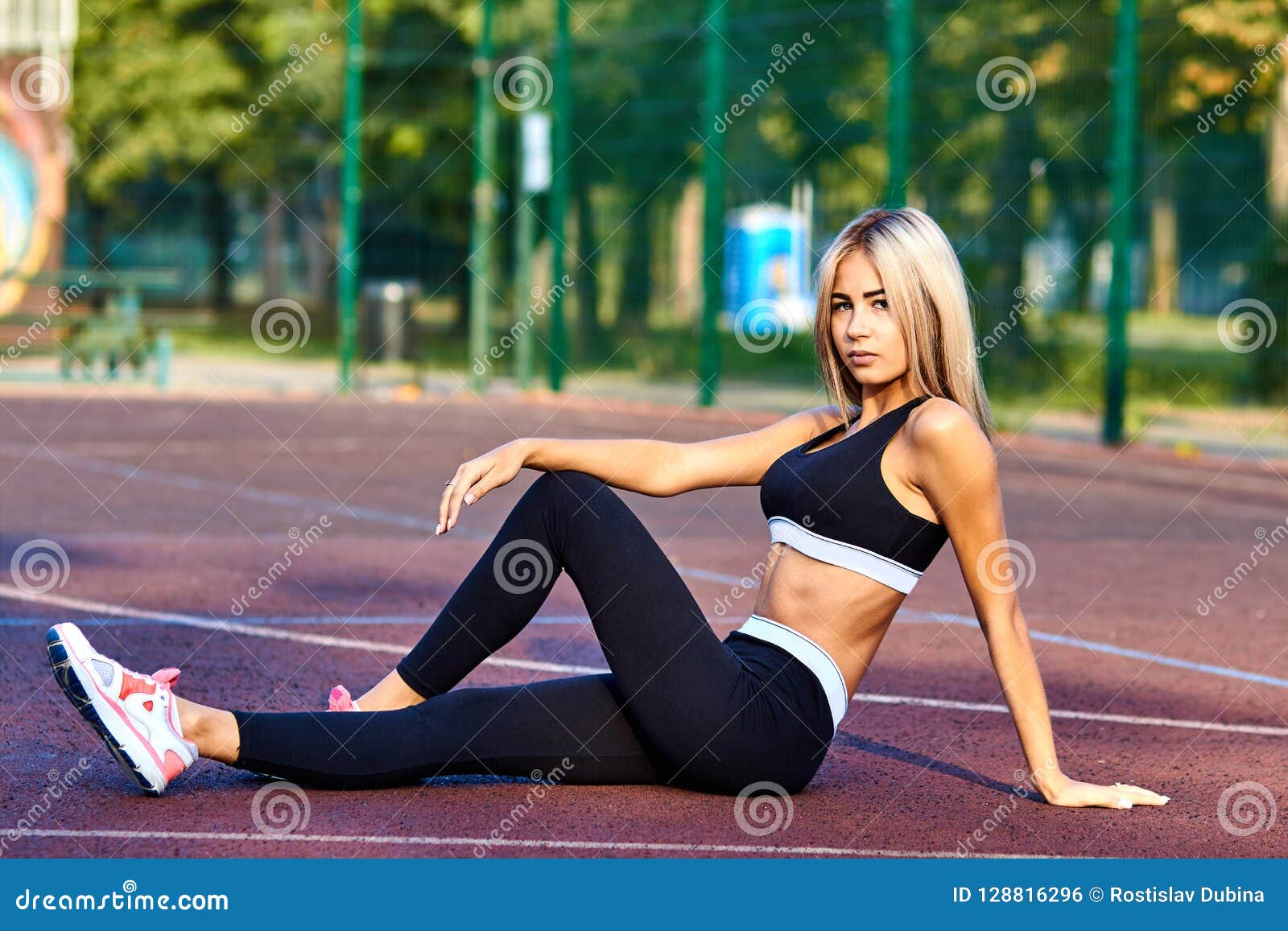 Beautiful athletic young girl in sportswear, doing exercises for