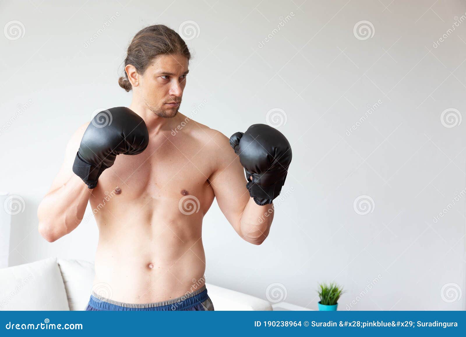 A Sport Man Has Boxing Training in His Living Room at Home Stock Photo
