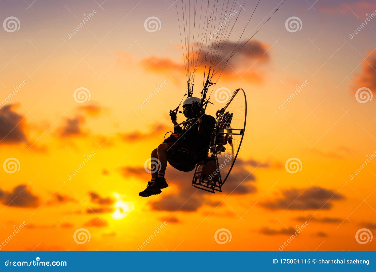 Sport Paramotor Over the Sky at Sunset and Beautiful Cloud Stock Photo