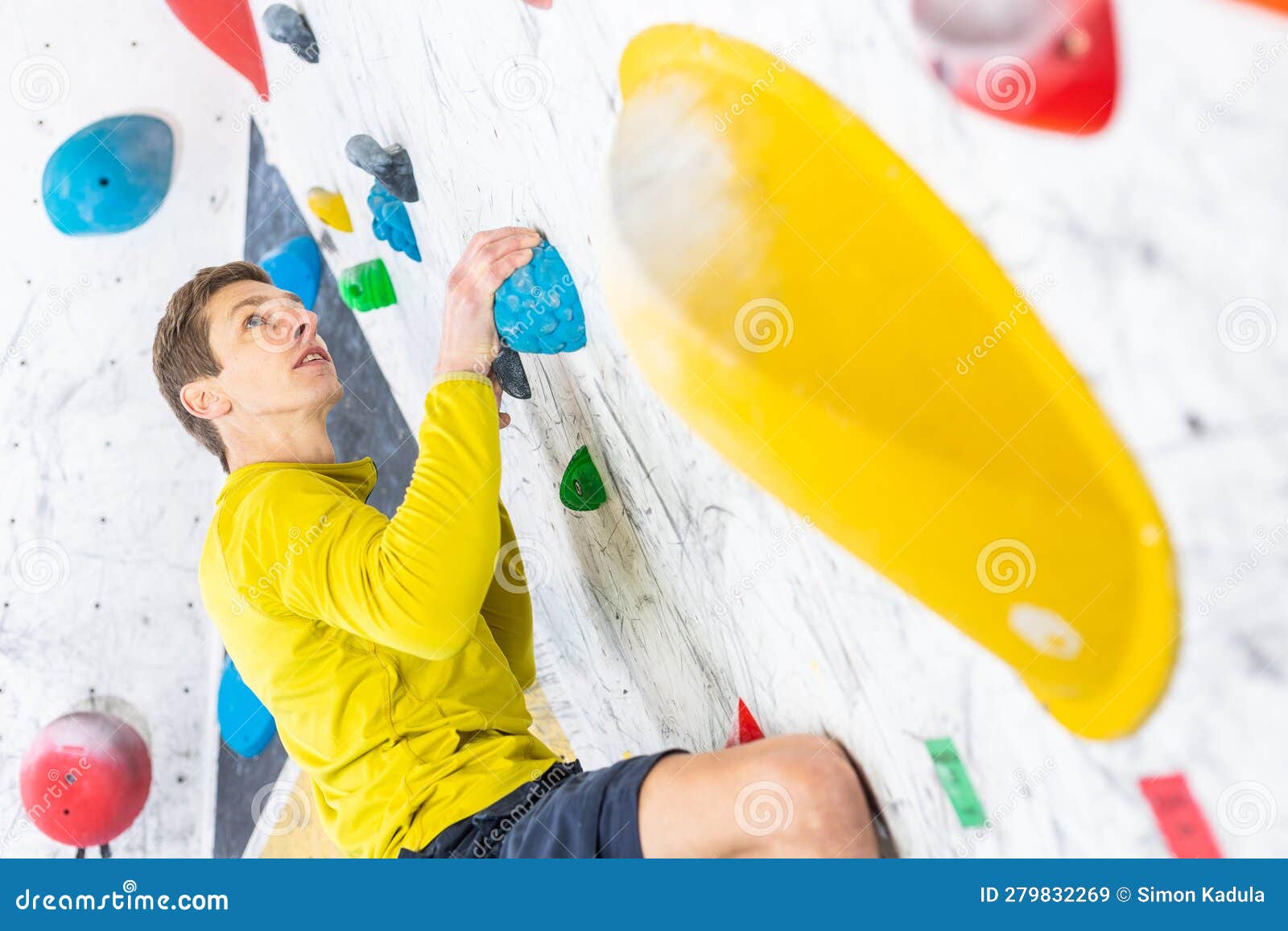 Sportive Man Climbing the Boulder Wall in a Climbing Centre, Sport