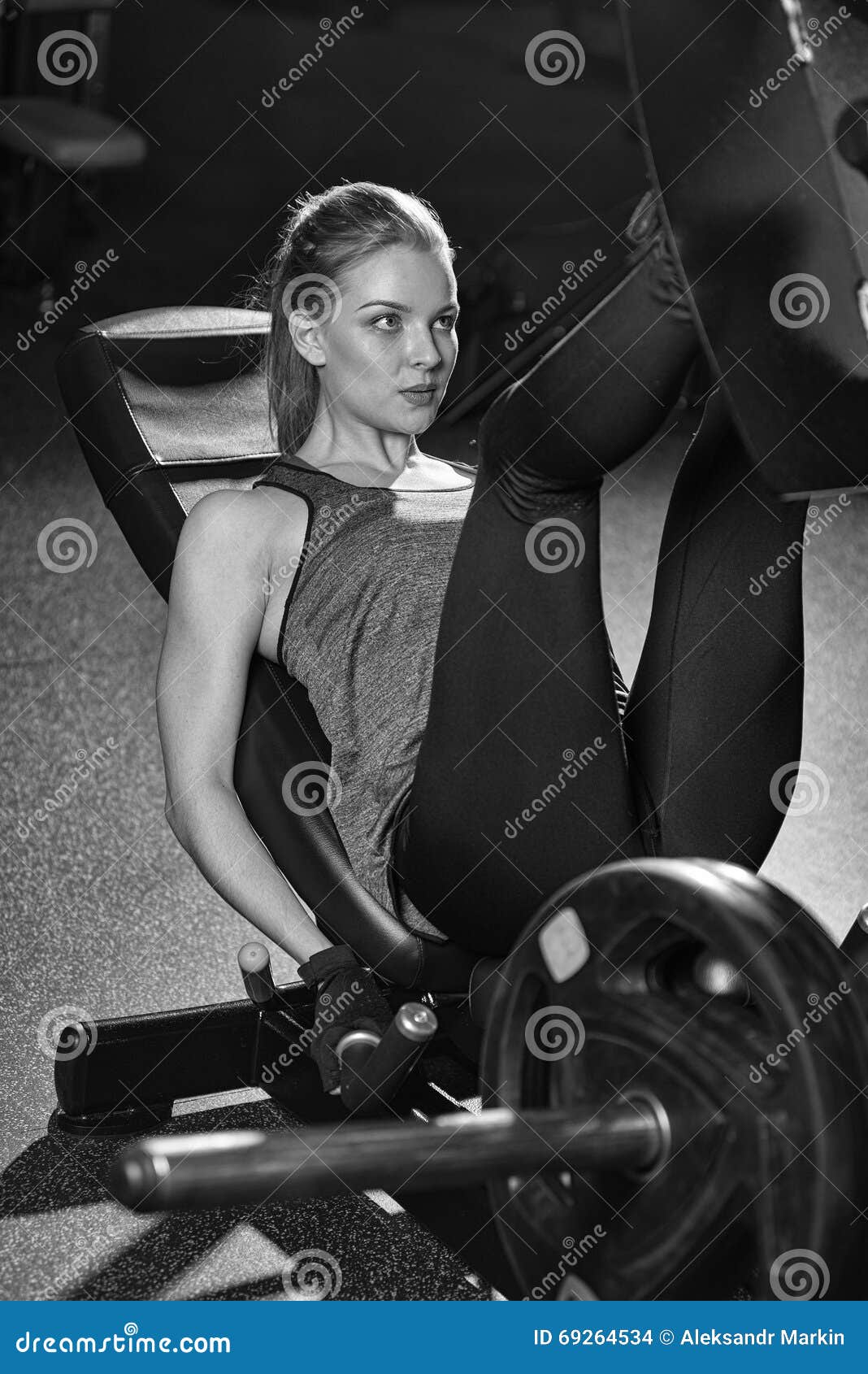 Sportive Woman Using Weights Press Machine for Legs. Gym. Stock Photo ...