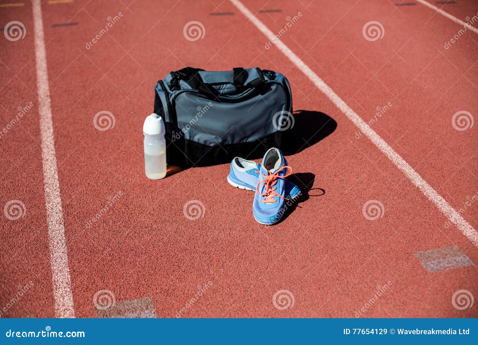 Female track and field athlete with water bottle and bag Stock Photo - Alamy