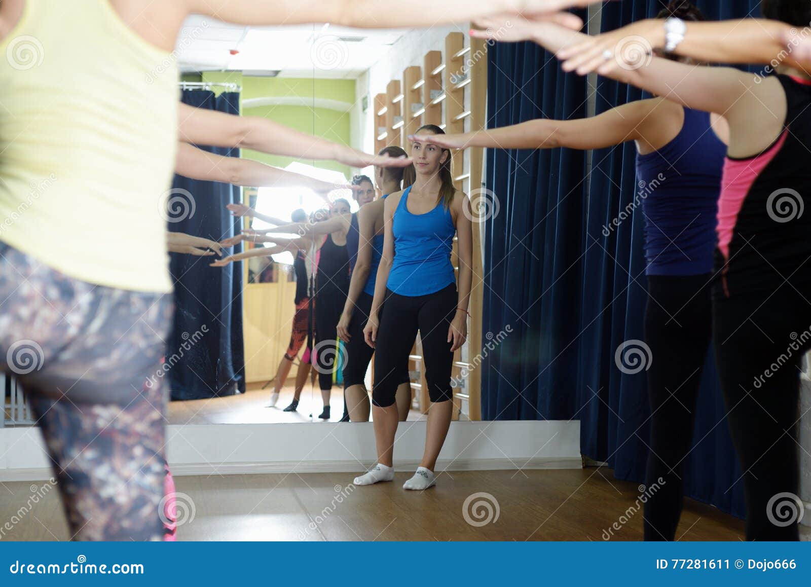 Sports Instructor Watches Performance of Exercises on an Extension