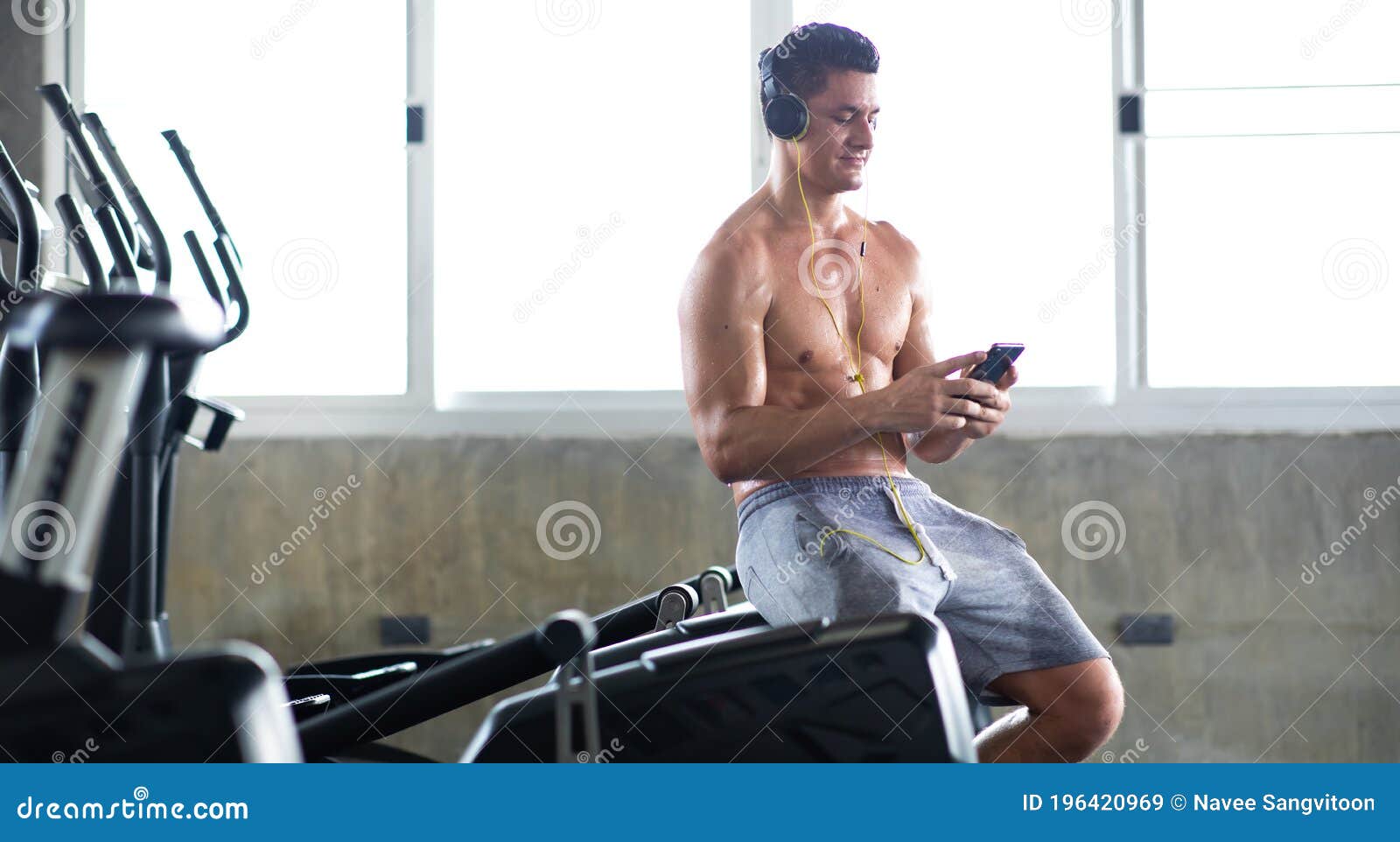 sportsman  taking a break after training at the gym sitting  and drinking water at sport club. fitness healthy lifestye and