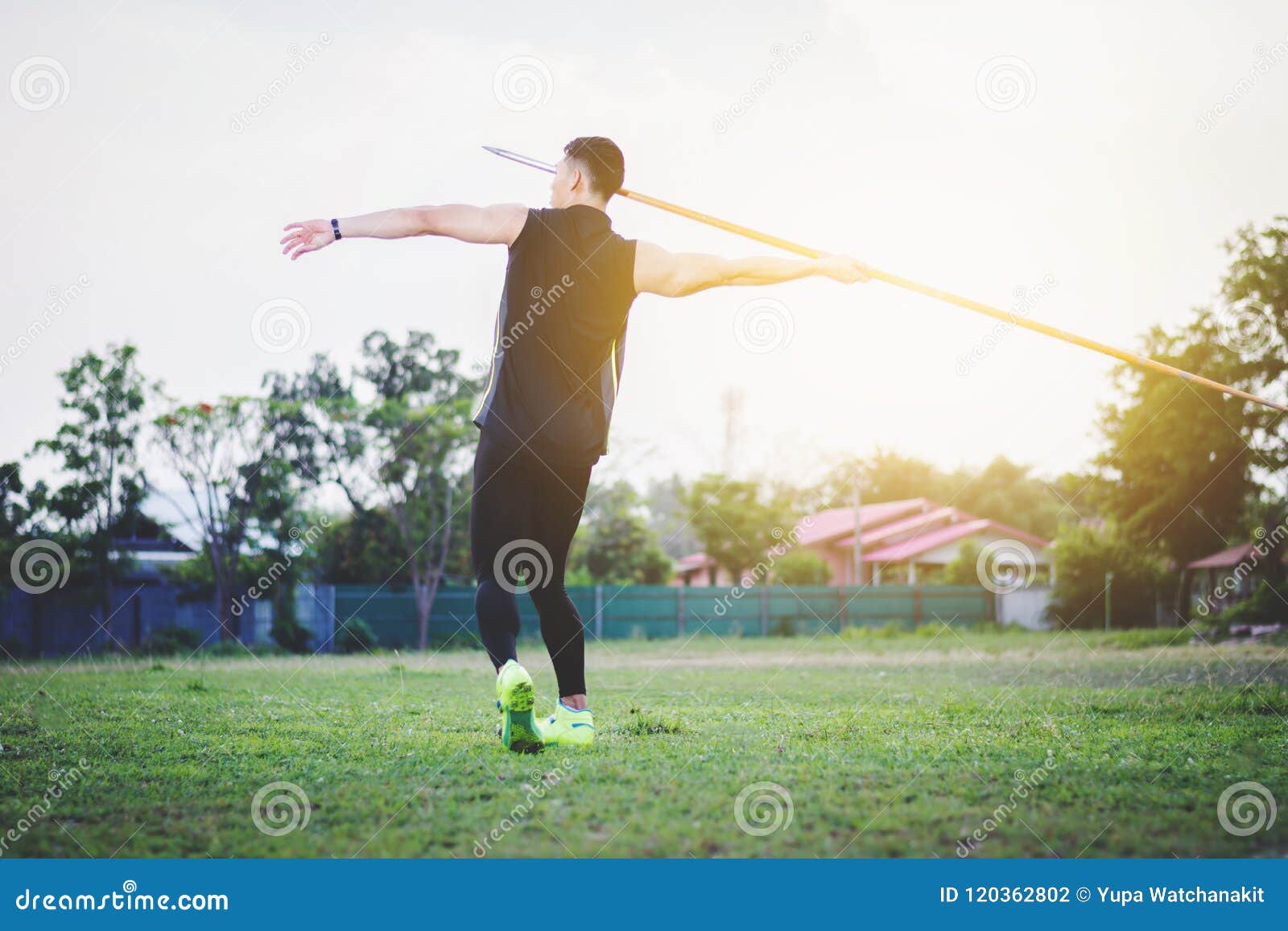 Man Warming Up and Practicing Javelin Throw in Yard Stock Photo Image