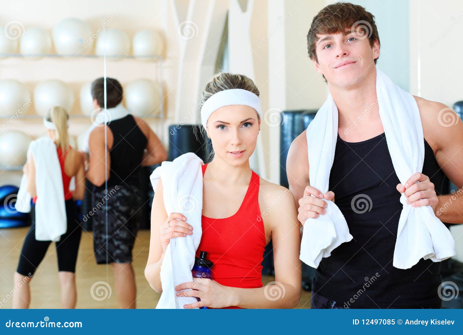 Sportsmen. Couple of a sporty young people in the gym centre.