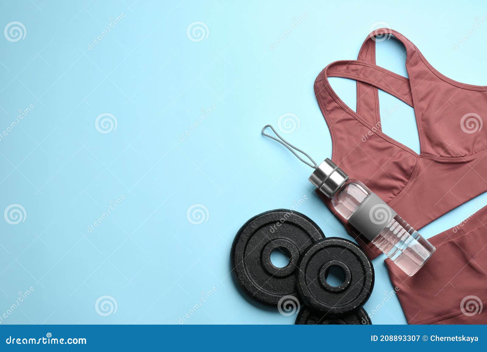 Sportswear, Weight Plates and Water Bottle on Light Blue Background ...