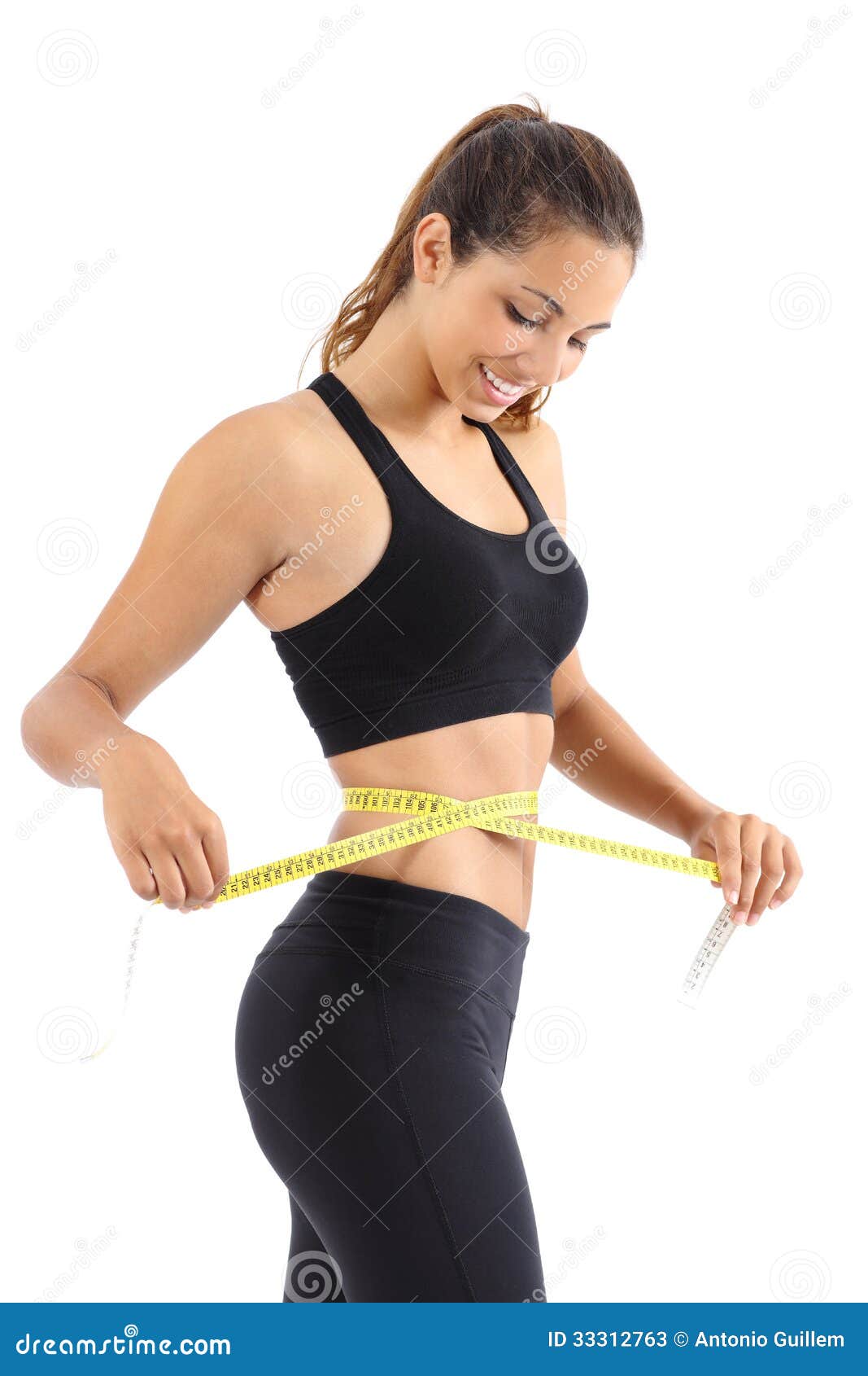 sportswoman measuring her waist with a measure tape