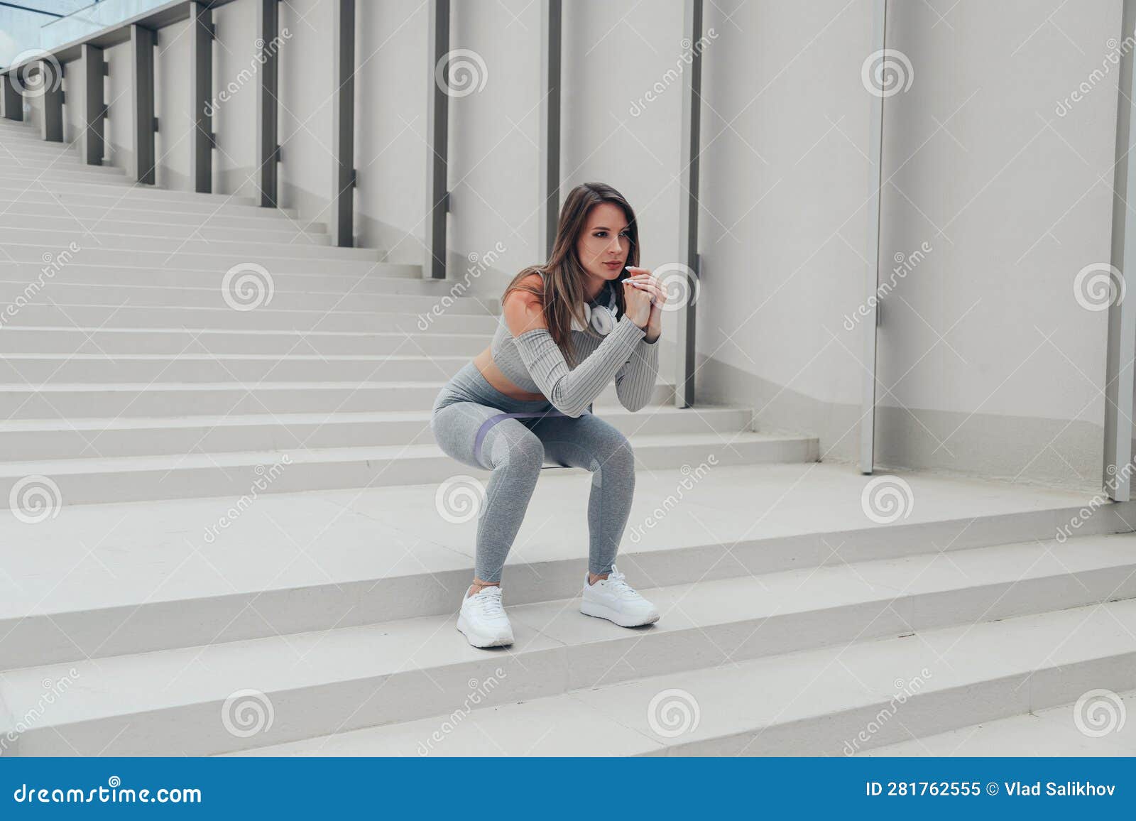 Sporty Athletic Woman In Grey Sportswear Doing Squatting With Gymnastic Elastic Bands Sit Ups