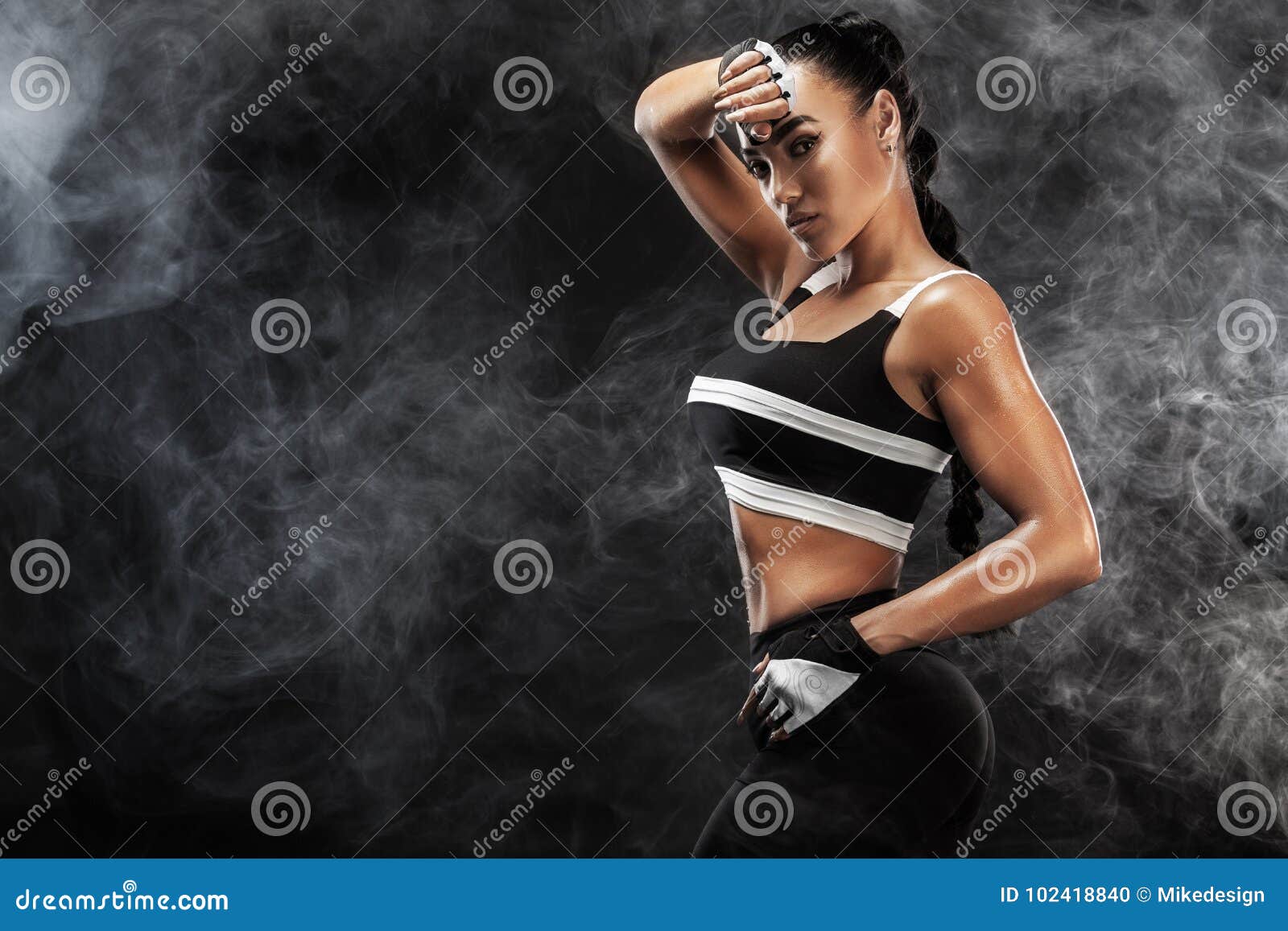 sporty beautiful afro-american model, woman in sportwear makes fitness exercising at black background to stay fit