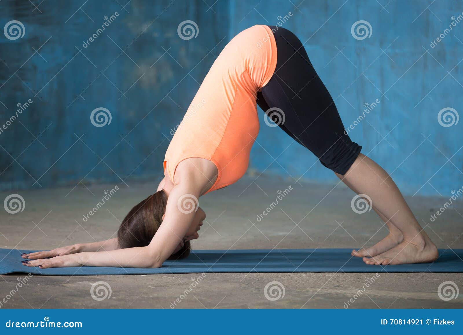 sporty beautiful young woman doing dolphin pose