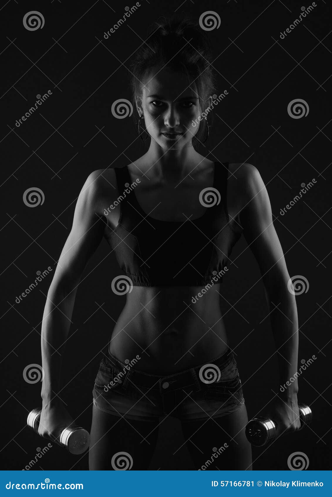Sporty Girl Doing Exercise with Dumbbells Bw Studio Shot Stock Image