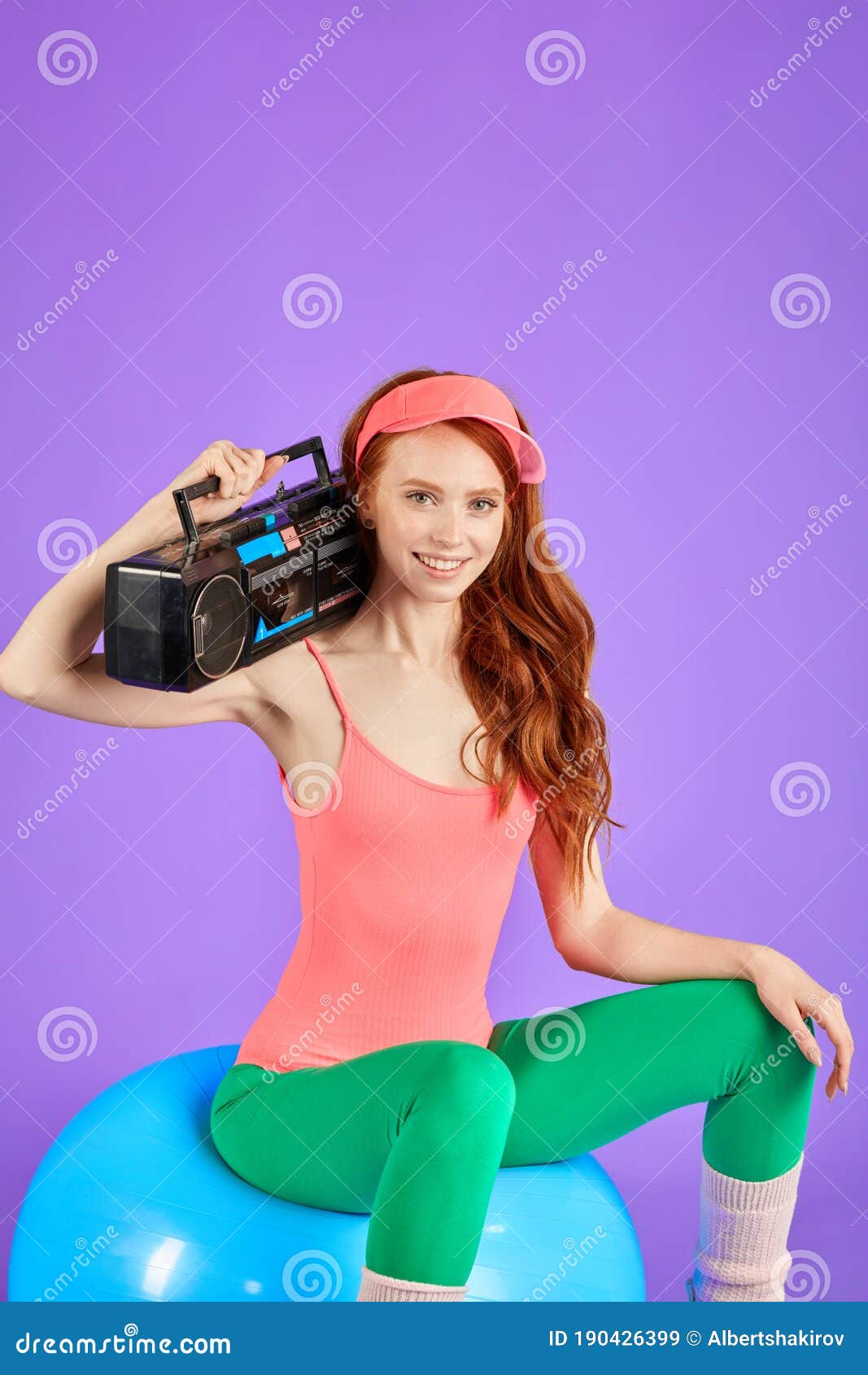 Sporty Girl Posing On Fitness Ball With Portable Cassette Player Stock