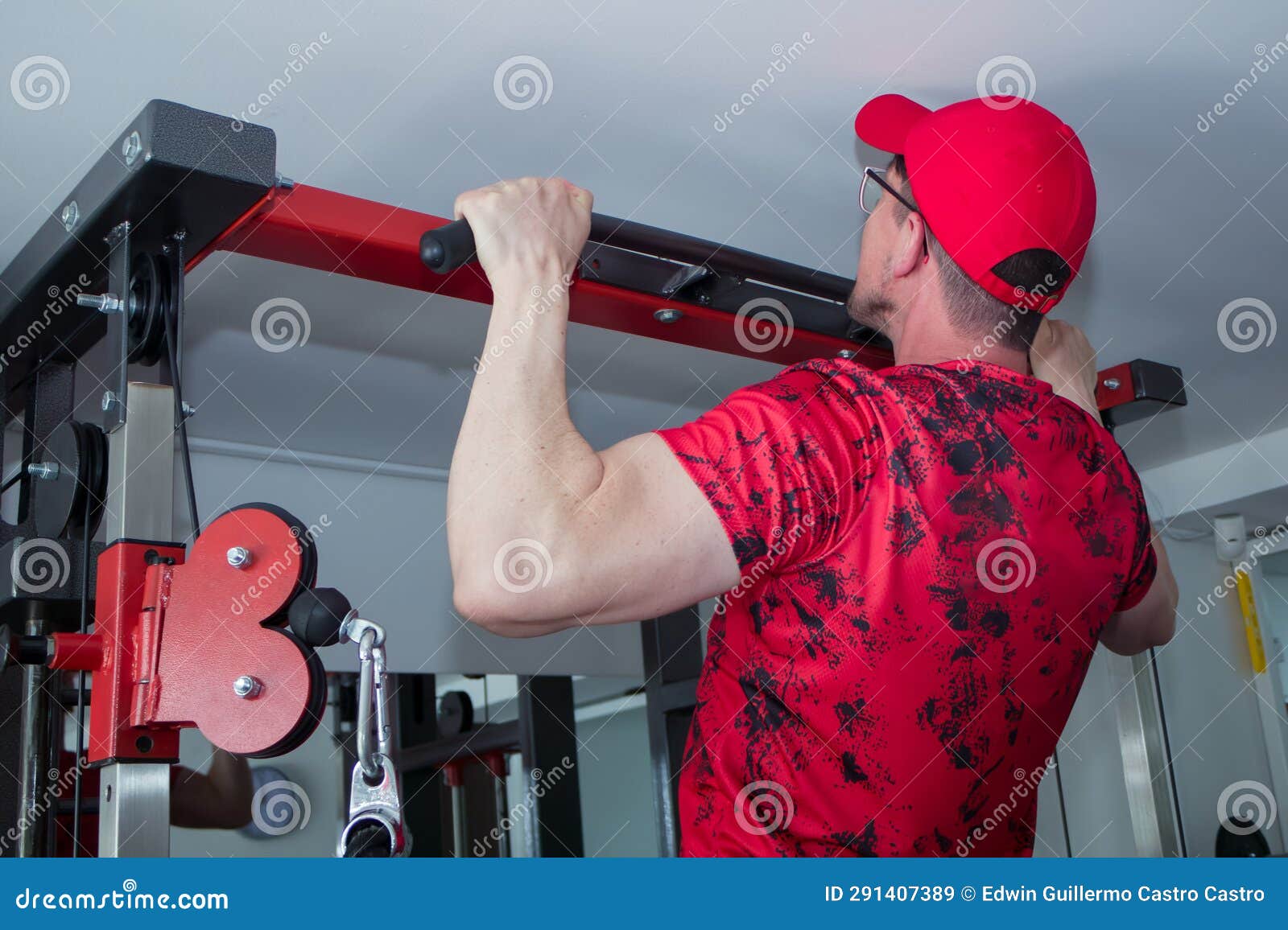 sporty man exercising on multi station at gym for arm and shoulders muscles. fitness exercising in gym