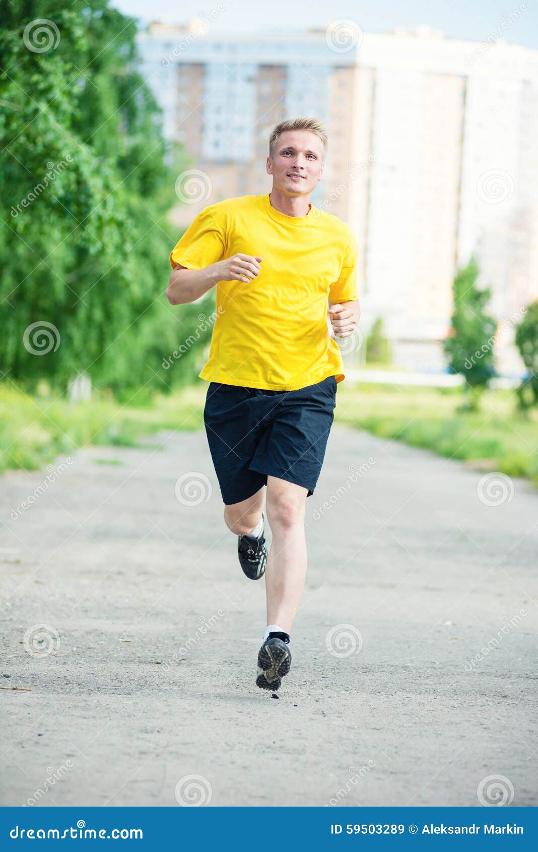 Sporty man jogging in a park stock photo