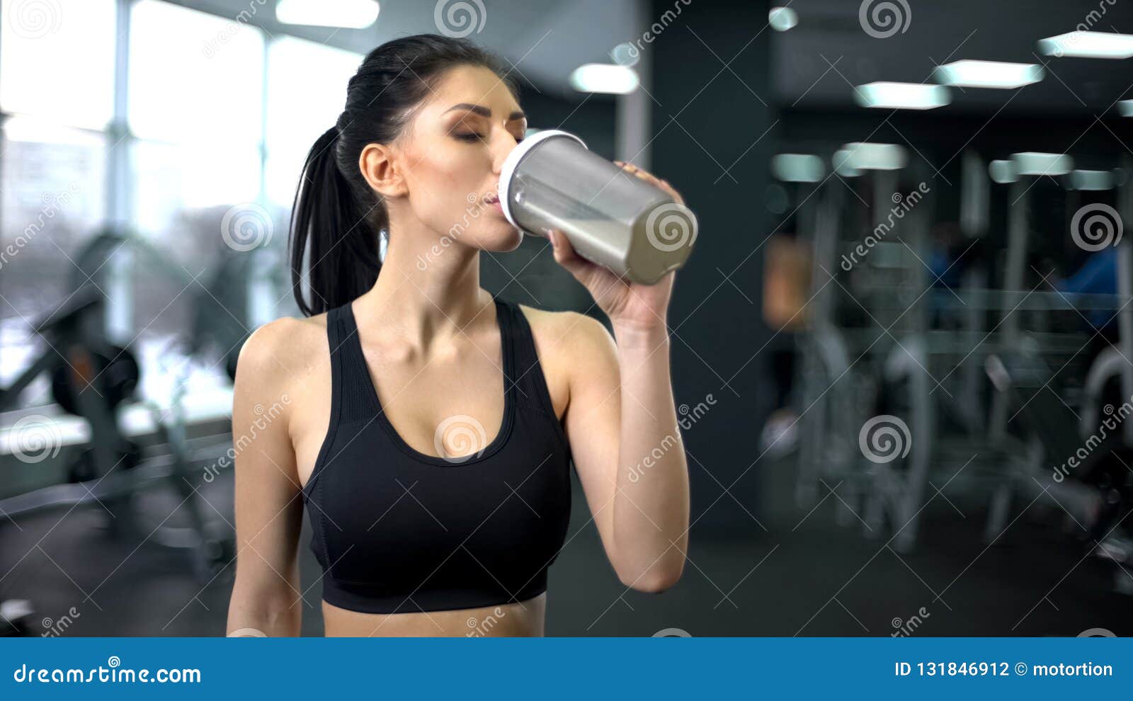 sporty woman drinking protein shake after workout, muscle gain nutrition, health