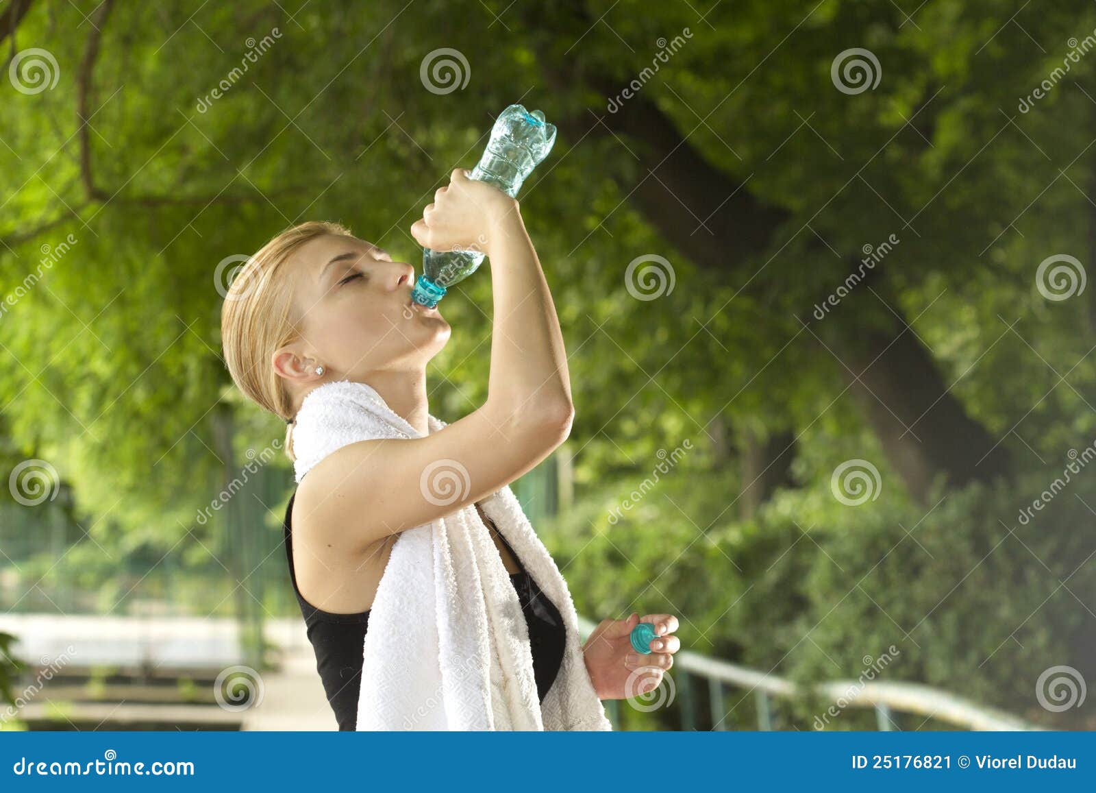 sporty woman drinking water