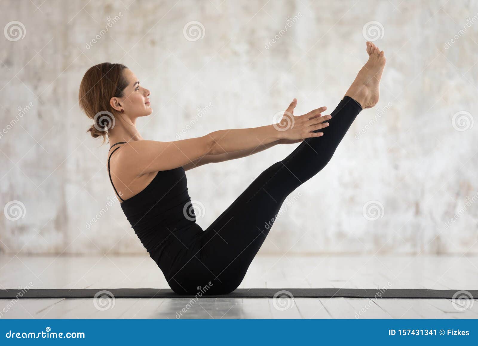 sporty woman practicing yoga, doing paripurna navasana exercise