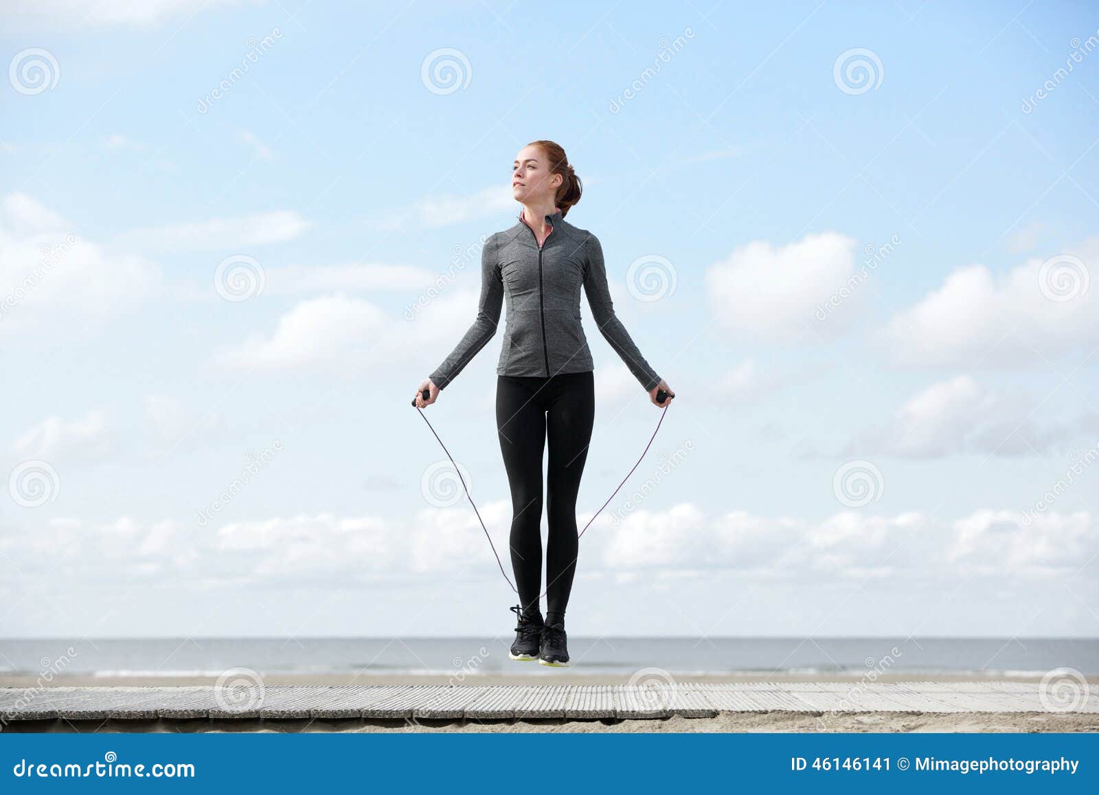 sporty woman warming up with jump rope