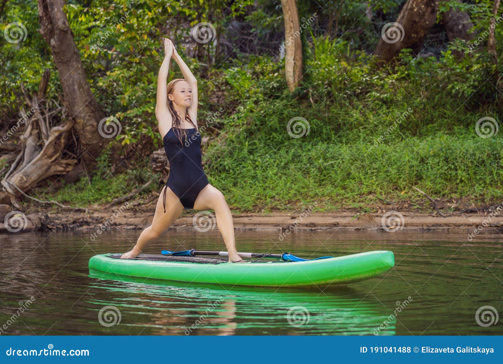 Sporty Woman in Yoga Position on Paddleboard, Doing Yoga on Sup Board ...