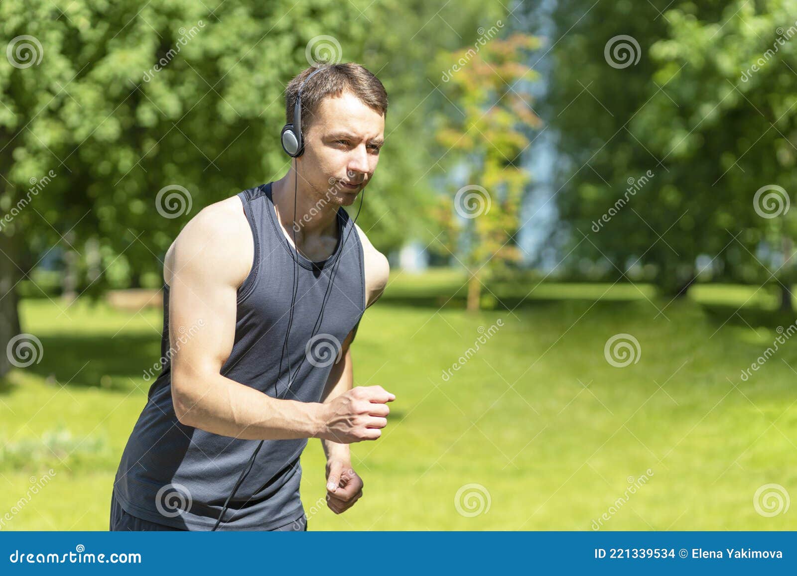 Grusom undulate Algebraisk Sporty Young Male Athlete Run and Listen Music with Headphones on Nature.  Guy Do Sport in the Park in City. Healthy Lifestyle. Stock Photo - Image of  concept, nature: 221339534