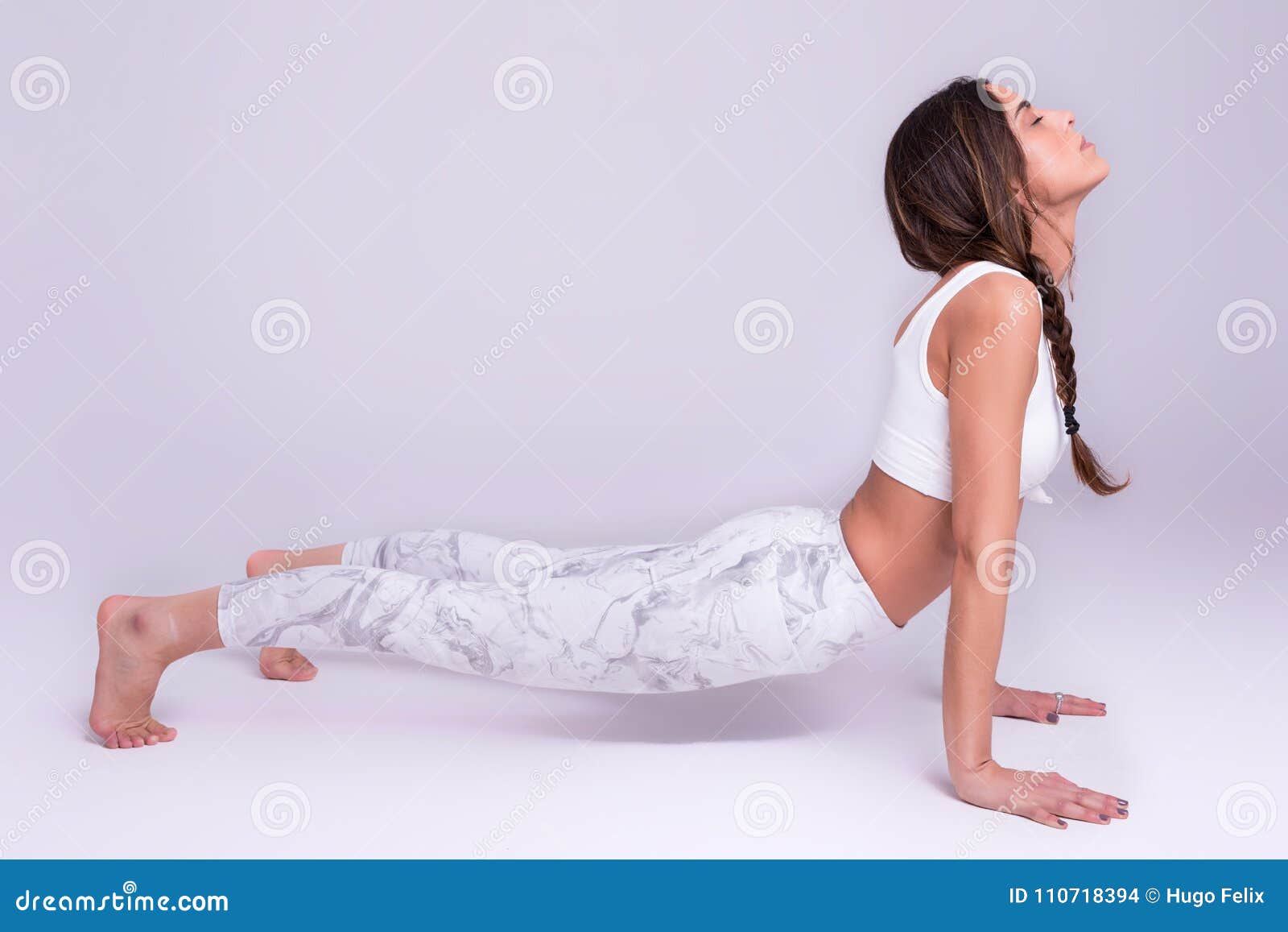 Sporty young woman doing yoga practice isolated on white