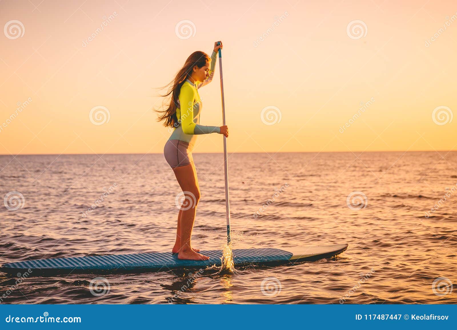 Sporty Young Woman at Stand Up Paddle Board with Beautiful Sunset ...