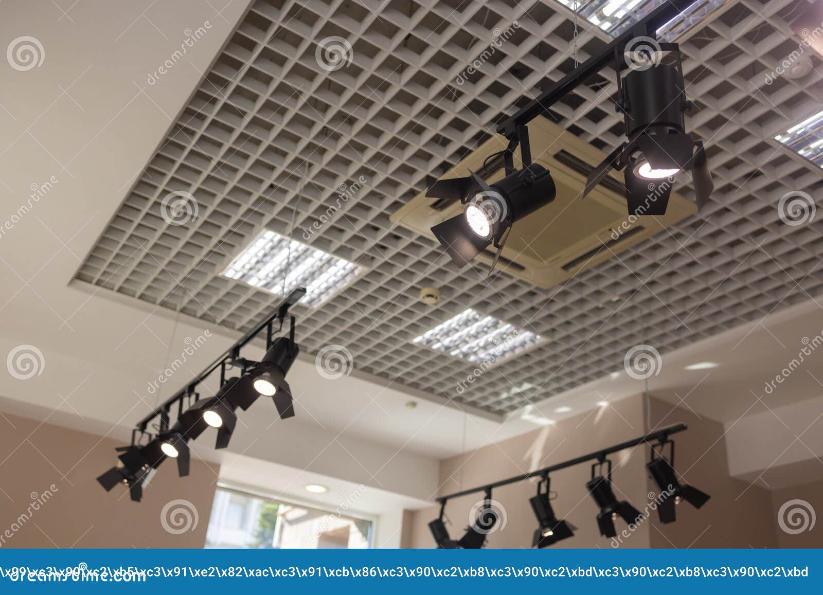 Tracking Spotlights Shines On The Ceiling Rail System Stock Photo