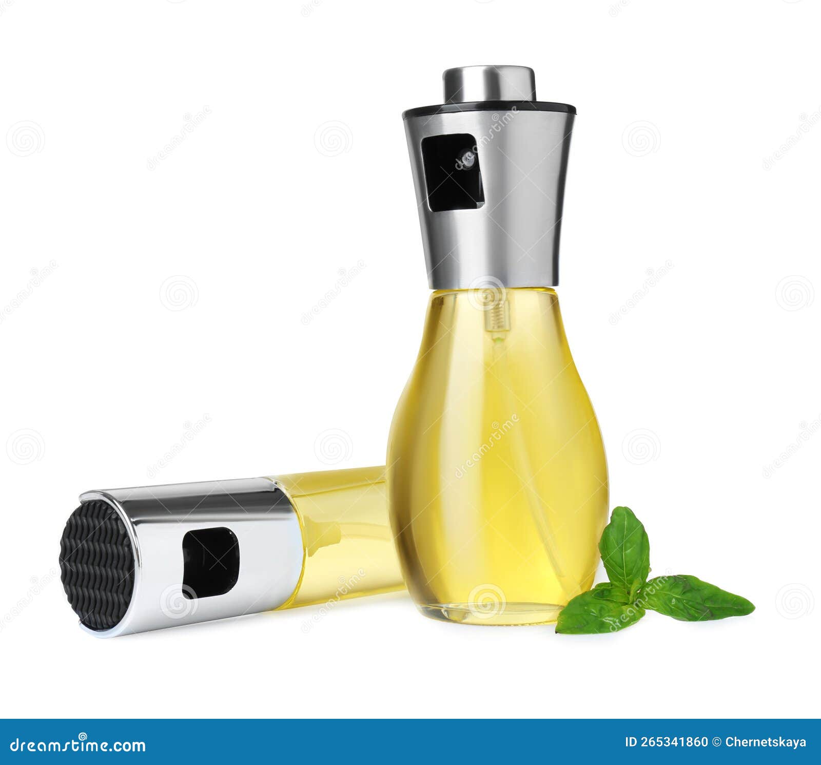 Spray Bottles of Cooking Oil and Basil Leaves on White Background Stock