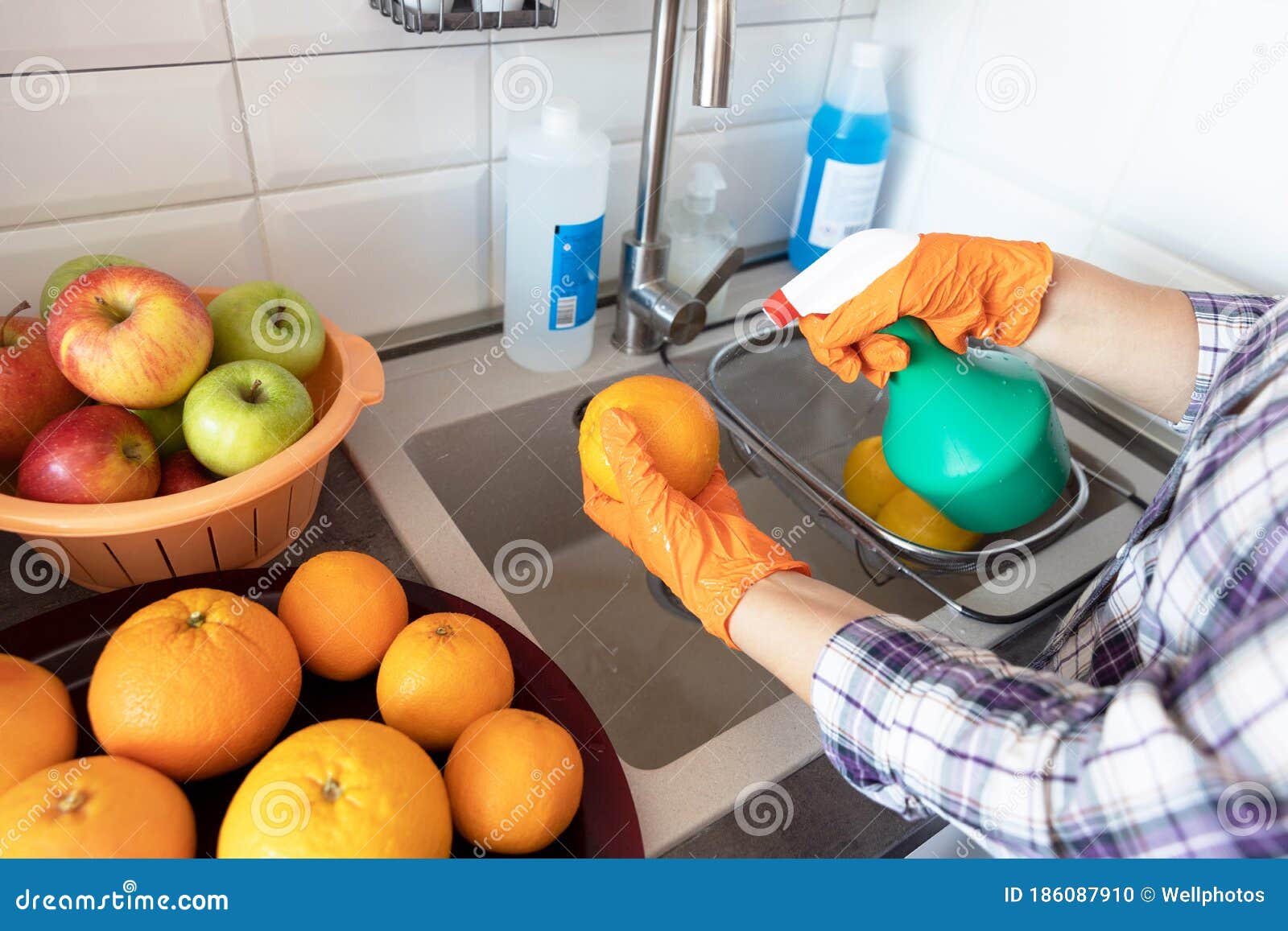 Spraying Disinfecting Chemical on the Fruit in the Kitchen Stock Photo