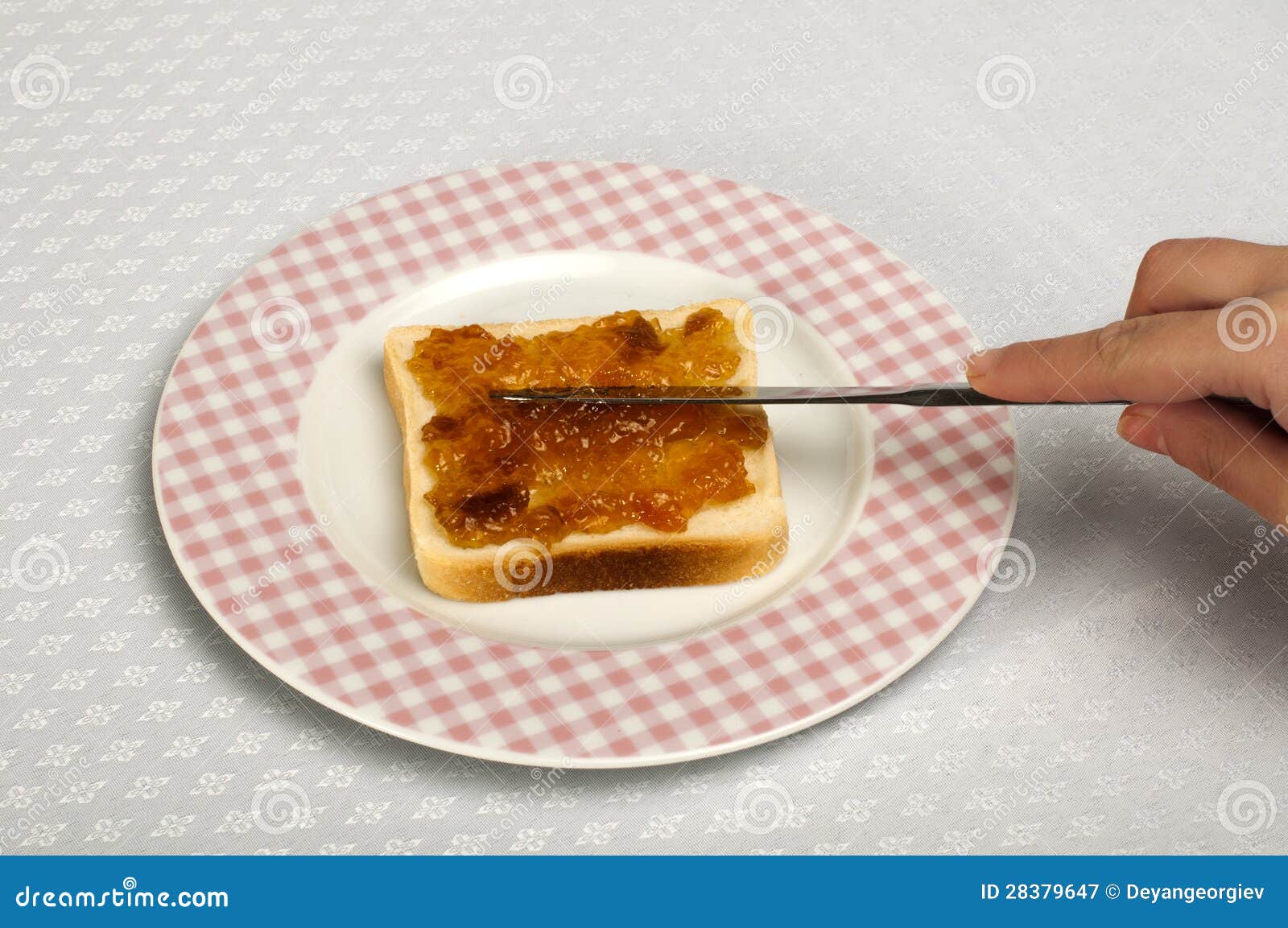 Spread jam on bread stock image. Image of food, hand 28379647