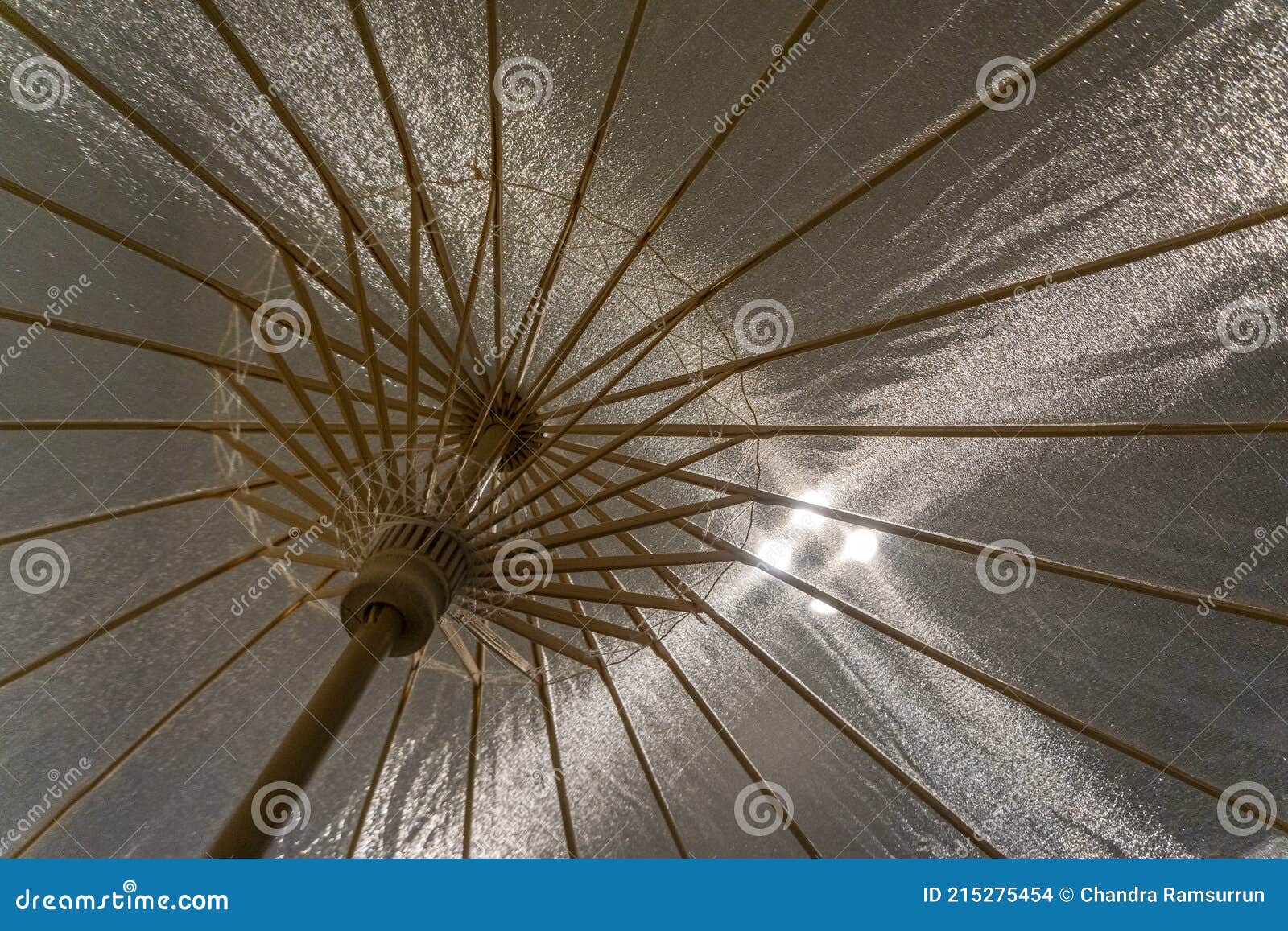 View of Spread Opened Umbrella with Backlight from Above Stock Photo