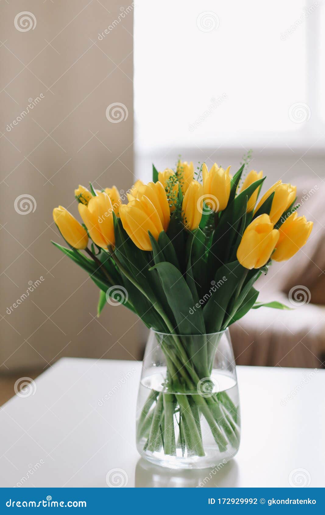 Spring Flowers in Living Room Interior. Bouquet of Fresh Yellow Tulips ...